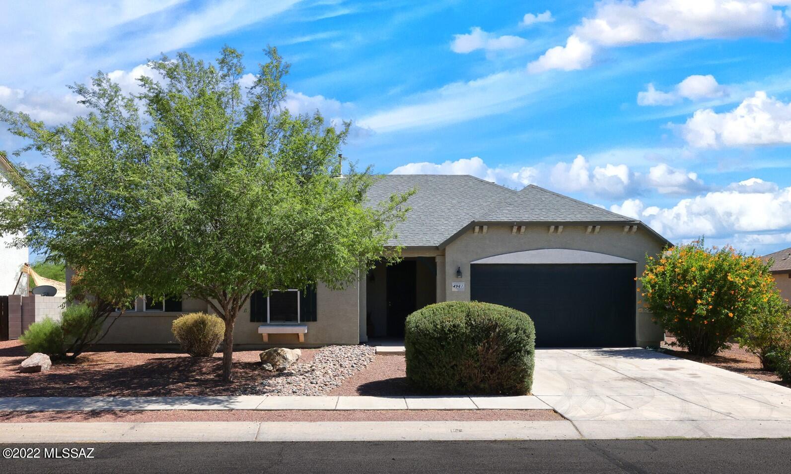 Very well manicured front yard, shutter style windows and a covered entry welcome you into this lovely 4 BR, 2BA home with 2 great living spaces, nice neutral tile in all the right places & a large walled-in wrap-around backyard that boasts beautiful mature trees, covered patio, low care decorative gravel and plenty of room for gardens, play areas and pets. Inside you will find lovely architectural details, a beautiful wall of windows allowing light to pour into the greatroom and an open kitchen w/double sink, gas range & lg pantry. The spacious primary bedroom offers a lg walk in closet, ensuite bath w/garden tub/shower combo. Good sized laundry room, a 2-car garage all in a nice established neighborhood!  Great location close to parks, hiking, shopping, schools & just minutes to I-10.