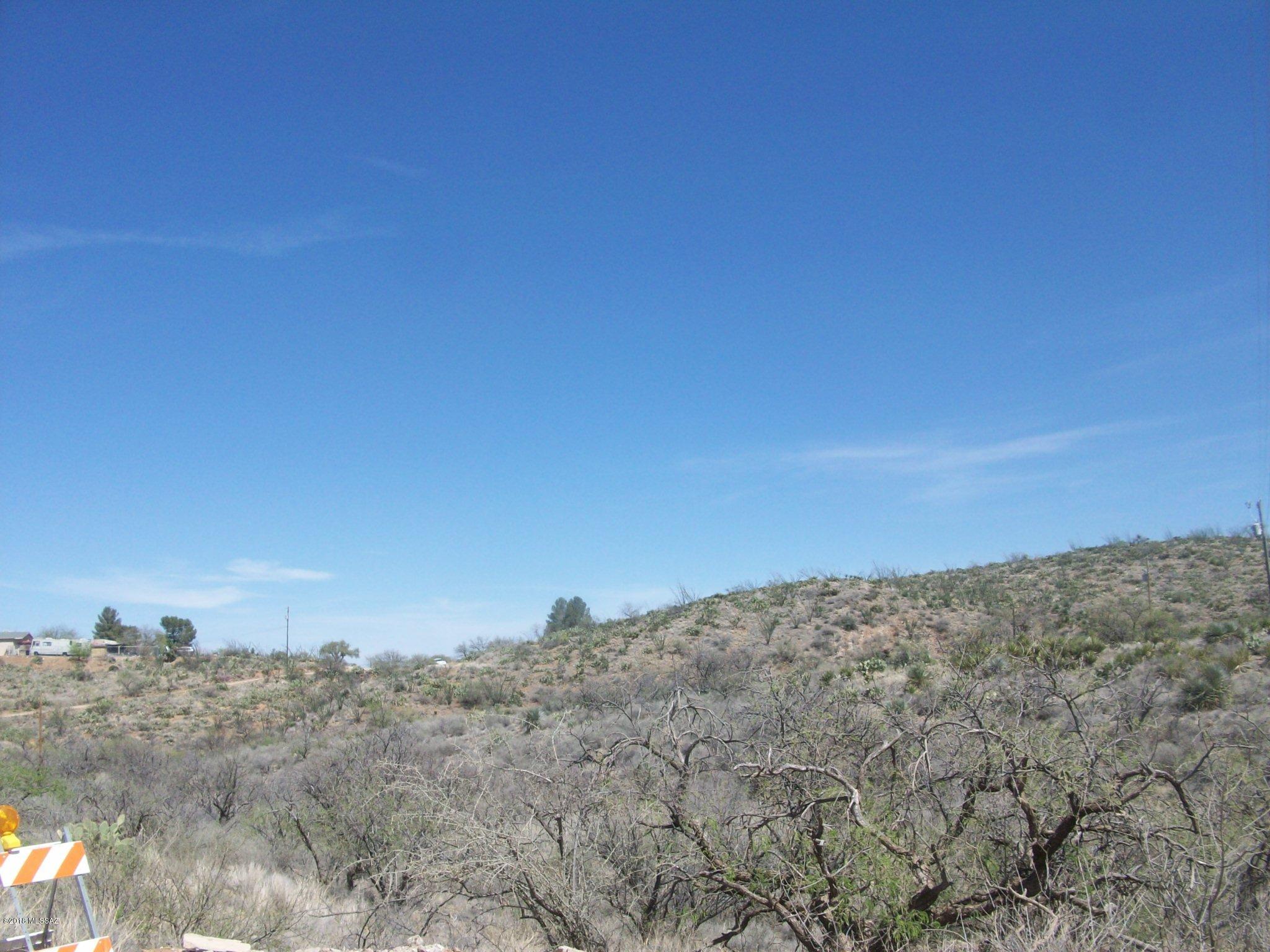 4.16 acres - Copper Cut Trl is a dirt road - this property is cut 1/4 X 3/4 by the roadway - larger portion on west side.  Surrounding homes are a distance away - many gated, some manufactured but, most site built homes - this property affords privacy and convenience.