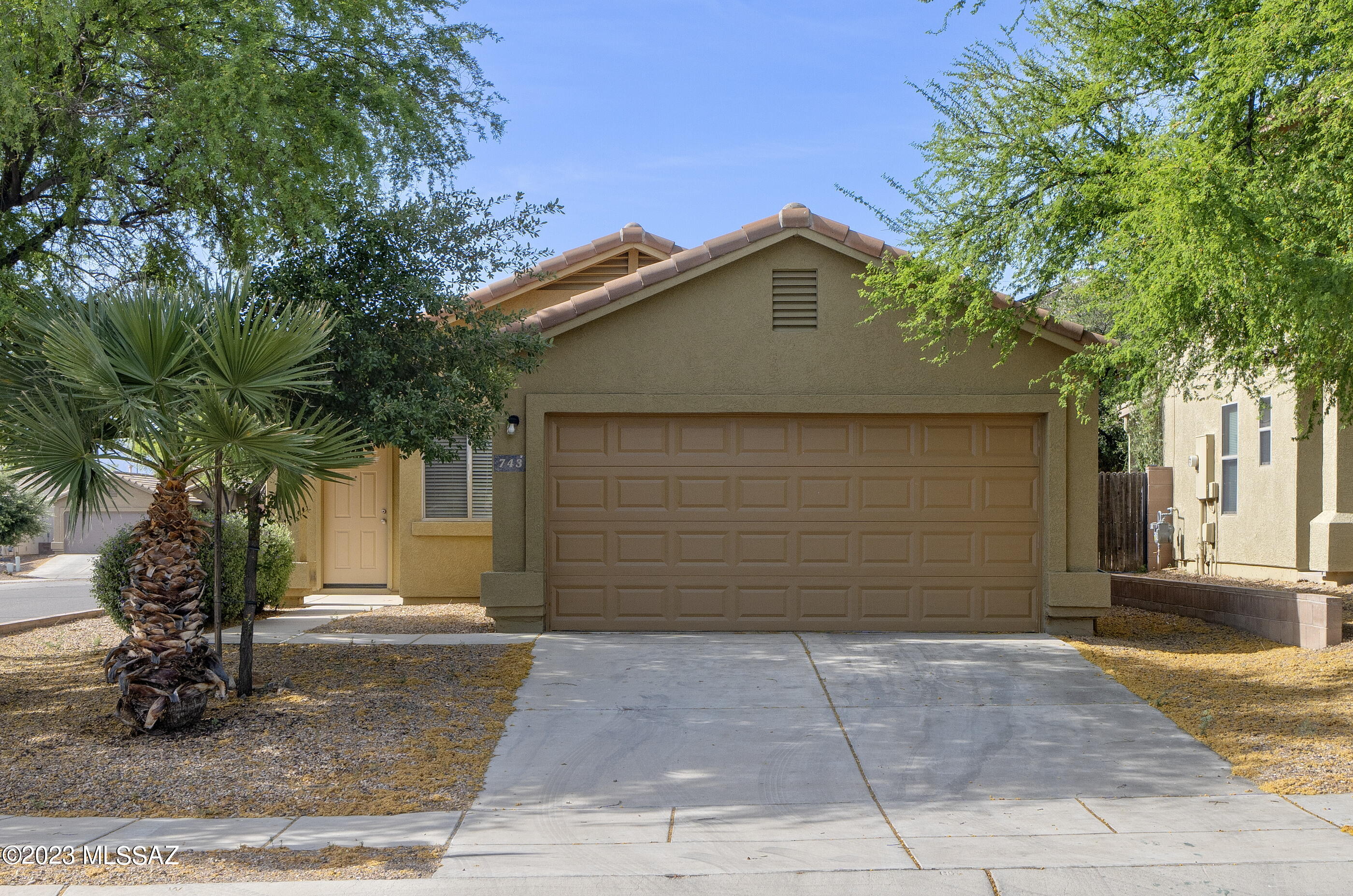 Three bedroom, two bath, one-story home is ready for new owners! No carpet in this 1094 square foot home—easy care ceramic and wood-look vinyl throughout. Sunny kitchen overlooks the backyard and has a closet pantry, stove, built-in microwave and dishwasher. Primary bedroom has its own full attached bath. Two other bedrooms are serviced by a full hall bath. Ceiling fans in living area and two bedrooms.  Outdoor space has a covered patio, is graveled and fully enclosed with a block wall. Easy access to I-19 and very close to shopping and dining, including a Wal-Mart SuperCenter and Sprouts Market. Corporate owned—please allow 72 hours response to offers, Monday-Friday.