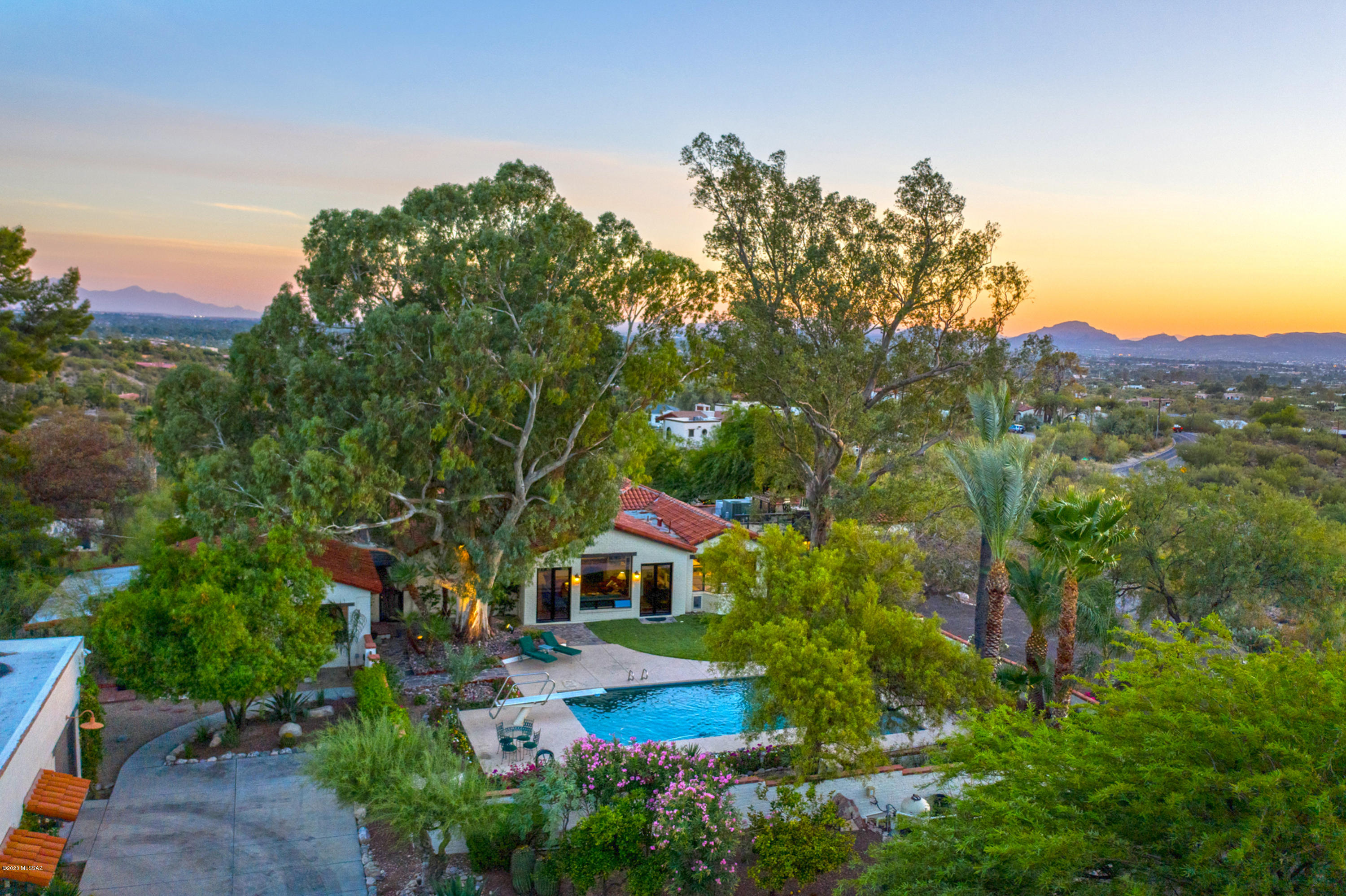 Classic ''Old'' Foothills Estate on a City & Mountain View 3.2 Acre Gated & Fenced Lot.  All the Charm, Character & Detail of a 1936 Joesler, designed or inspired, now an enlarged/updated 5BR/3.5BA Main House & 1BR/1BA Guest House. Also a Pool, Green House & 7 Car Detached Garage/Shop. Main House - Large Formal Living Room, Formal Dining, a new 2019 Kitchen, Spacious Family Room/Wet Bar. Current Owners (40+Years) added a 4 Room Master Suite - Office/Den/Library to Bedroom w/Views/FP to a Walk In Closet (room sized) and Full Bath.  Spacious Outdoor Patio w/ Fountain & Fireplace adjoins an Outdoor Covered Patio. 1940 Guest House w/Formal LR/FP, Formal DR, View Patio, Full Basement Storage. Garage, a Car Lover's Dream w/7 Spaces (3 Lifts). Truly the Finest of Tucson's Indoor/Outdoor Lifestyle