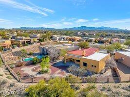 This tranquil and private retreat, in the lovely gated golf course community of WingView at Rancho del Lago, is on the market for the first time. It is perfectly poised against the backdrop of the Rincon Mountains, natural desert, unspoiled sunrises and a glimpse of the nearby Del Lago Golf Course.  All this can be enjoyed from the covered back patio and oversized backyard with view fencing providing the ideal spots to unwind and savor the southwest ambiance. Entering the home through the courtyard welcomes you to the great room. You are greeted with lots of personality including deep décor-ready niches, exceptional architectural details, high ceilings, a fireplace to keep cozy during the winter, and freshly painted neutral colors throughout. Keep cool with ceiling fans in all bedrooms and in the Great Room. The roomy 3 car garage is home to the water softener and a utility sink; the garages have always been used as storage and a WORKSHOP (cars have not marred the floors). Its location is amazing with award-winning Vail schools, convenience of grocery, banks, restaurants, recreation (the Del Lago Golf Course and Club House) as well as easy access to the I-10 corridor making daily life more convenient; everything is close but yet so private and quiet on a cul-de-sac. The home resides in a family-friendly neighborhood with close access to the neighborhood pool & hot tub, walking paths and Del Lago Clubhouse and golf course. The home is also perfect for "Lock and Leave".