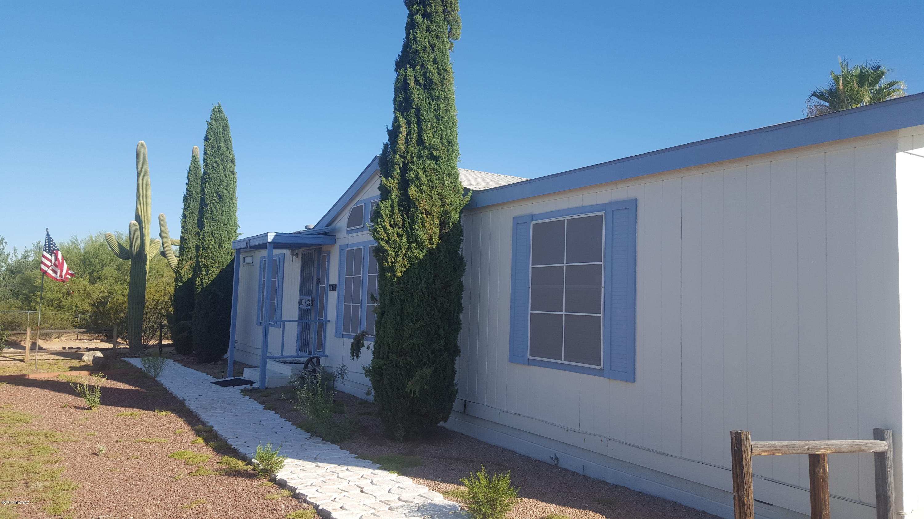 Beautifully maintained home in one of the few paved subdivisions in Picture Rocks at end of cul-de-sac for added privacy nestled near Saguaro National Park West and only 15 minutes from I-10/Cortaro Farms Rd. with oodles of shopping/restaurants/medical, etc... Recently painted (exterior),  new a/c gas pac installed 2018 as well as updated pool equipment! Wonderful covered rear patio overlooking in-ground pool with water feature and privacy wall. 2 car garage and storage shed included!! Interior boasts family room and living room, split bedroom floorplan, spacious kitchen with island, 2 x 6 construction, tape and textured walls! Nice architectural windows for ample light!  Picture Rocks is a beautiful community boasting 3 stores, 2 mini markets/gas stations, community center, restaurant health clinic, community pool/park/skateboarding, local elementary school and newer fire station, all this only 15 minutes to the hustle/bustle of town! Come check it out! You will not be disappointed! NEW ROOF! CLEAR TERMITE REPORT! CLEAR ENGINEER CERTIFICATION!