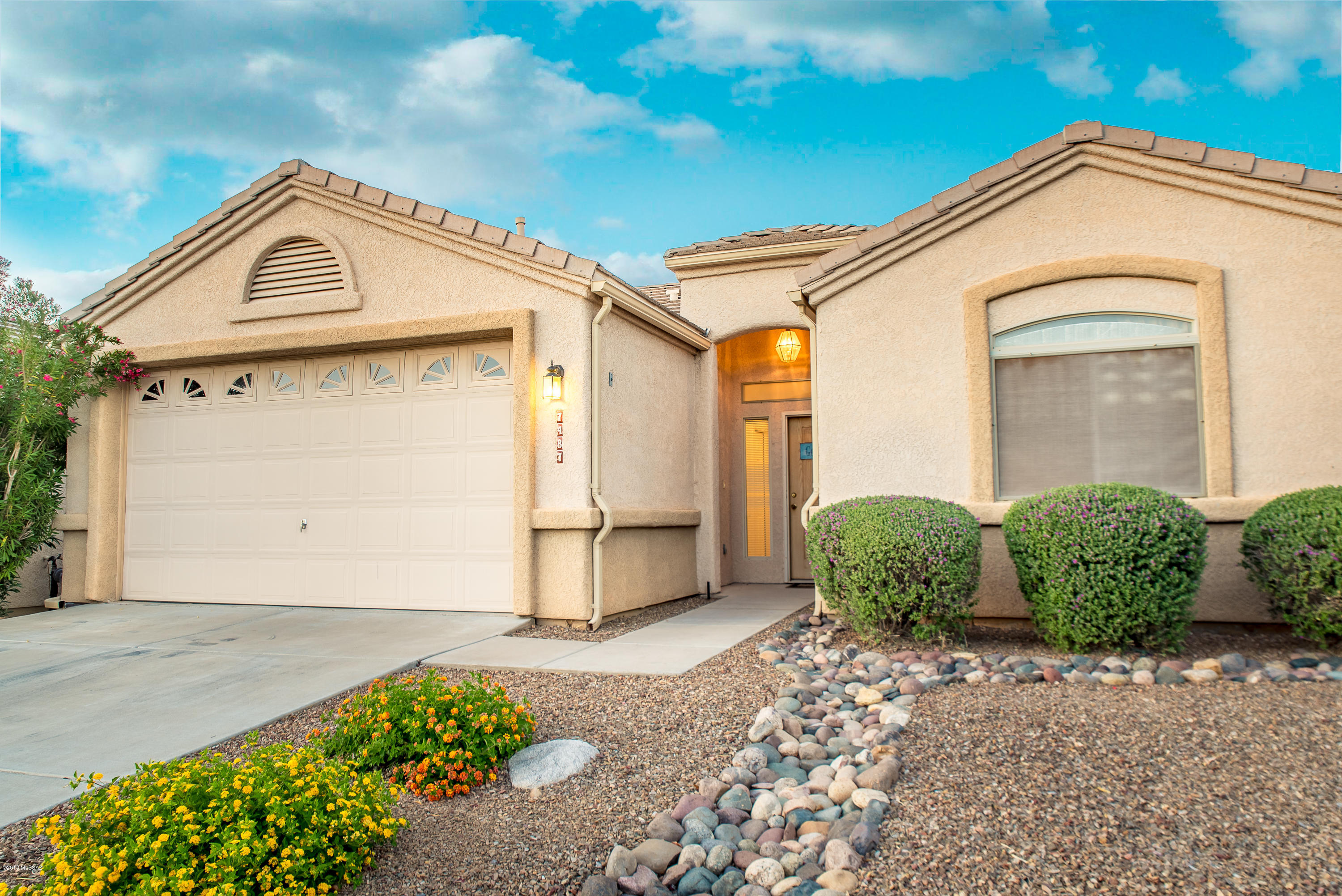 Welcome to The Voyager, active adult 55+ gated community.  Move in ready 1,812 Sq Ft, split floor plan single story w/ no steps, and attached finished two car garage (w/additional storage). Low maintenance inside and out, perfect for seasonal visitors with quick access to I-10.  Features & upgrades:  concrete tile roof, tile flooring, energy efficient double pane windows, custom window blinds & window covers, ceiling fans, no popcorn ceilings, water softener, recessed lighting, skylights, updated lighting and fixtures, internal laundry room w/ washer & dryer plus rolling pull outs for storage. Open concept kitchen remodeled with full slab granite island, counters and backsplash, double under mount sink, updated stainless steel appliances, recent cherry cabinets, water filter, built-in CONT microwave. Updated bathrooms include full slab granite and updated vanity & mirrors in both, tiled shower and jetted tub in guest w/dual sinks large walk in closet in spacious master bathroom suite.  Carpet in bedrooms, master bedrooms includes a built in den/office/exercise space.  Low maintenance backyard include long covered patio and sellers paid to have privacy wall finished with stucco.  The Voyager adult community offers several heated pools and spas, gated, security patrol, putting green, tennis courts, shuffle board and plenty of community events and activities.  Come view for yourself today.