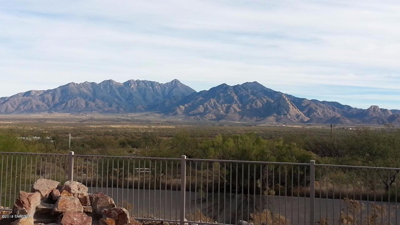 If Mountain views of the Santa Rita's that are unobstructed are a must have then don't miss seeing this home. A comfortable size home at 1602 sq ft that has 2 bedrooms, 2 baths and a nice size den. Features include 36'' Hickory cabinets with beautiful granite counters ,crown molding, under cabinet lighting and pullouts in the kitchen cabinets . Polished concrete floors in the kitchen ,living room and den, with beautiful wood flooring in both bedrooms. A large rock water feature  is the focal point of the rear patio. A well maintained home that shows pride of ownership.