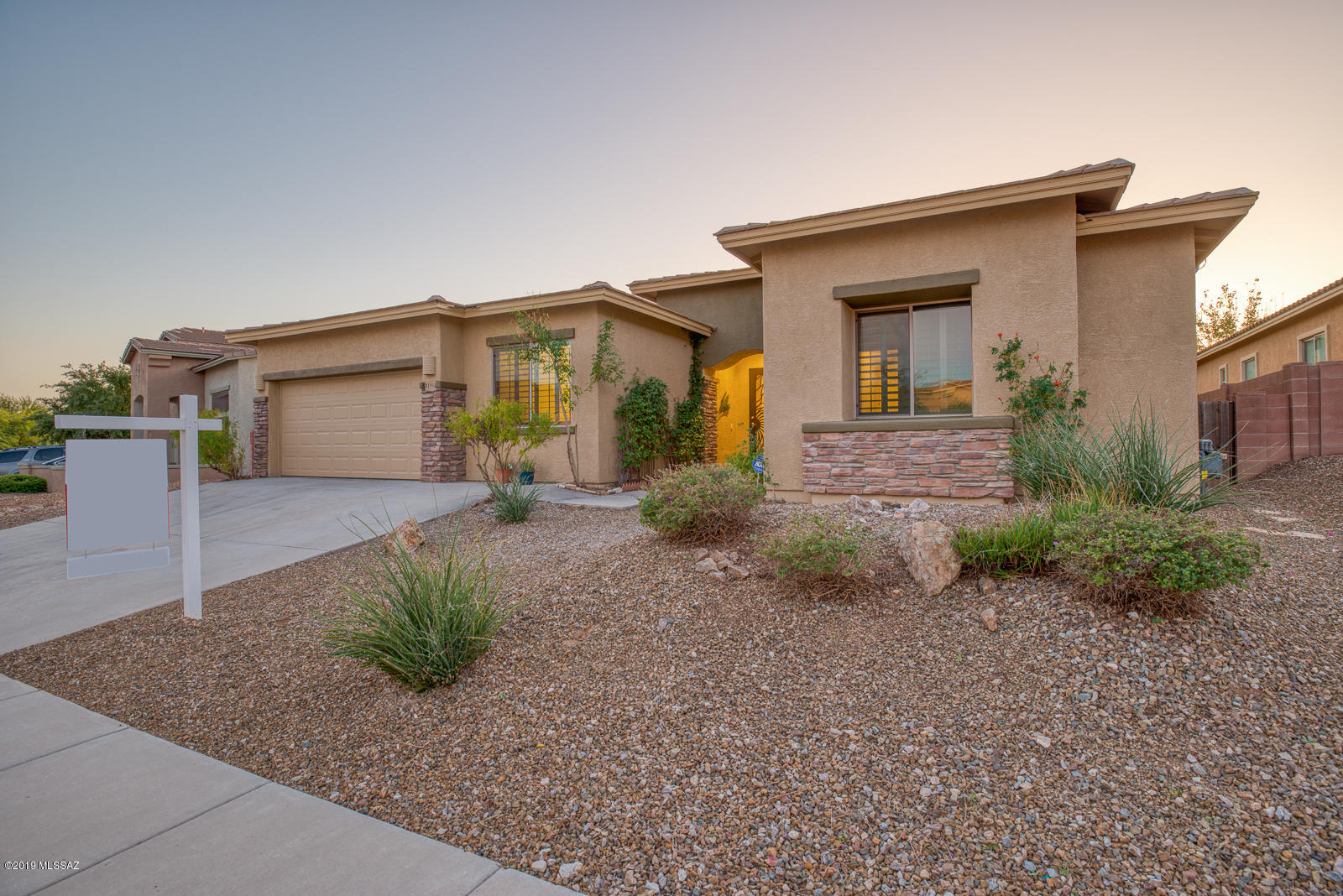 This stunning, single story home in OV has many upgrades and fantastic curb appeal. Gorgeous, rich, dark tile flooring in the living space and bedrooms is warm and inviting. Floor to ceiling feature wall with fireplace is complete with hearth and custom stacked stone. The large kitchen has custom tile work flooring and backsplash, ample two-toned custom cabinets, double oven, stainless dishwasher, floating shelves, plenty of counter space and an island for prep. The master bath is expansive with its large shower, garden tub, vanity and upgraded light fixtures. Classy, dark plantation shutters grace the home's windows. The backyard is an entertainer's dream with a large fenced pool and spa, landscaping, flagstones, and grass area.