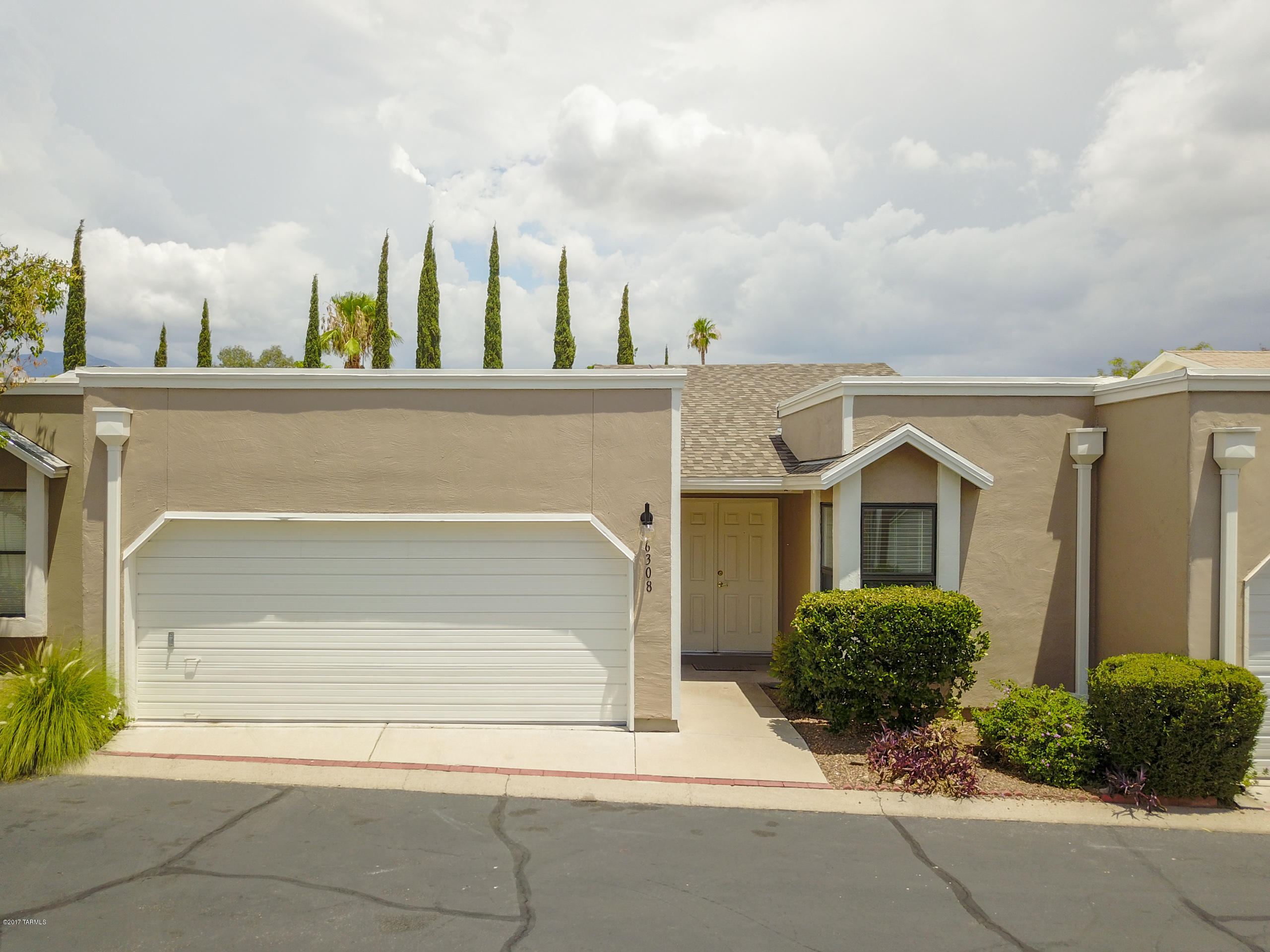 This 2 bed 2 bath +DEN townhome is clean and move-in ready. The bright and airy floor plan has high ceilings and plenty of natural light looking out onto the outdoor patio space. Upgrades include beautiful stamped concrete floors, new carpet in the bedrooms (installed July 2017), refinished counter tops, and freshly painted. The fireplace in the living room and upgraded light fixtures are great accents. This home also has 2 car garage and community pool. All this in the highly desirable neighborhood of Casas Adobes!