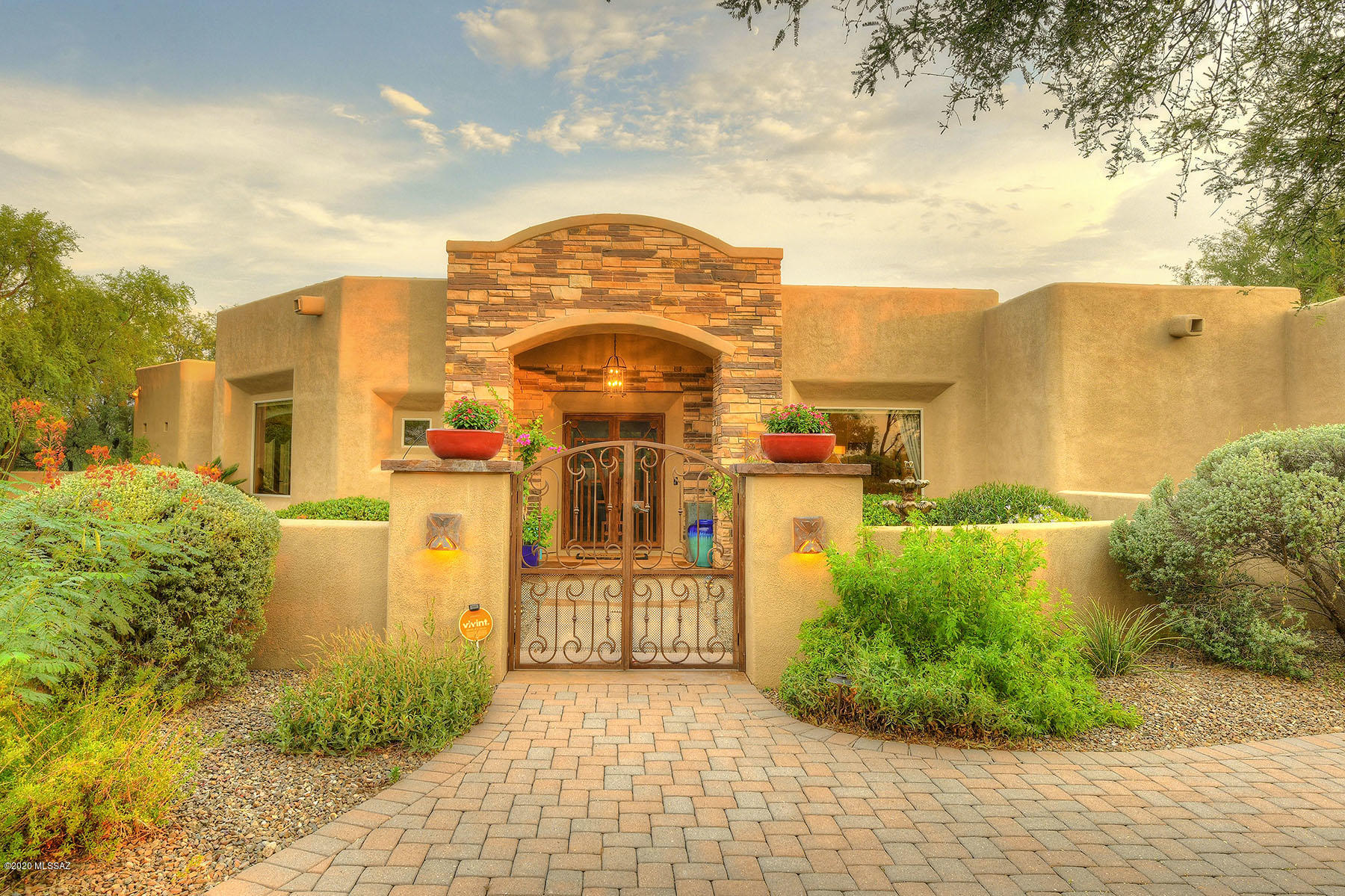 Resort Style living! Custom contemporary home nestled in Tanque Verde valley. Lush courtyard w/ fountain & putting green welcomes you. Soaring ceilings in great room w/ picture windows open to beautiful patio w/ covered seating area, fireplace & bbq Ramada. House renovations include all 4 bathrooms completely updated, kitchen remodel & more.Split floor plan w/ 4 large bedrms, 4 bath & media/game room. Modern kitchen w/walk-in pantry, granite counter tops, SS appliances, oversized island & eat-in nook for casual dining. Relaxing & spacious Master suite w/ walk-in closet & updated bathroom+steam shower. Backyard also boasts saltwater pool w/ slide&jacuzzi, low maintenance turf yard w/ swings. Oversized 3 car garage w/ separate storage rm. Total Privacy on .92 of an acre. Tanque Verde Schools