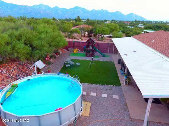 Welcome home! Check out the stunning views of the Catalina mountains! This attractive, well maintained 4 bedroom, 2 bath property is located on over over an acre of land. The back yard is an entertaining dream with tons of privacy, above ground pool and covered patio with misters for the AZ heat. All stainless steel kitchen appliances, split floor plan, vaulted ceilings, master bath soaker tub and much more! Sit on the front porch and watch the sun go down. This Catalina Gem won't last long, move in ready!