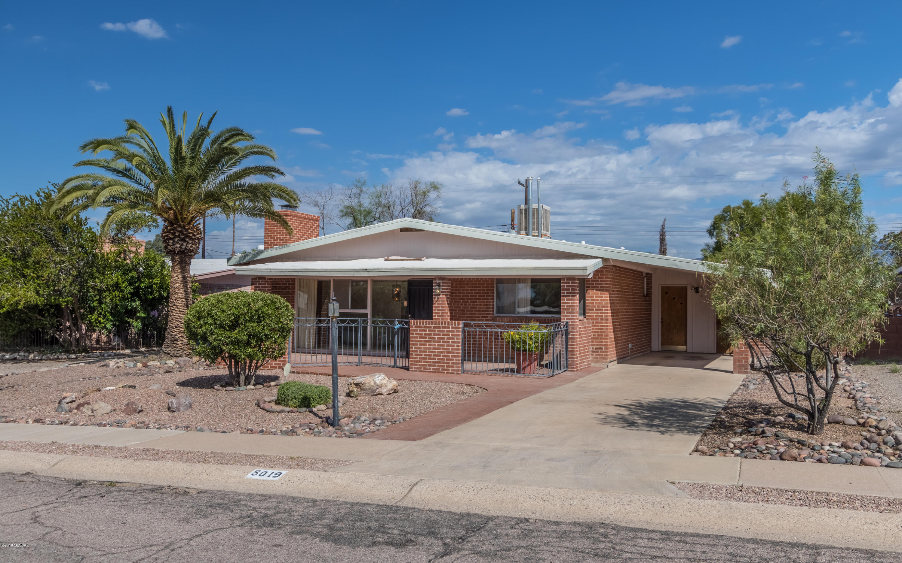Cute mid-century modern red brick home in great neighborhood! Northfacing backyard comes complete with mountain views and sparkling pool! Neighborhood park two blocks away! Perfect location - close to shopping, business and restaurants. Sellers have never lived in home. Estate sale.  Home being sold in As Is condition.