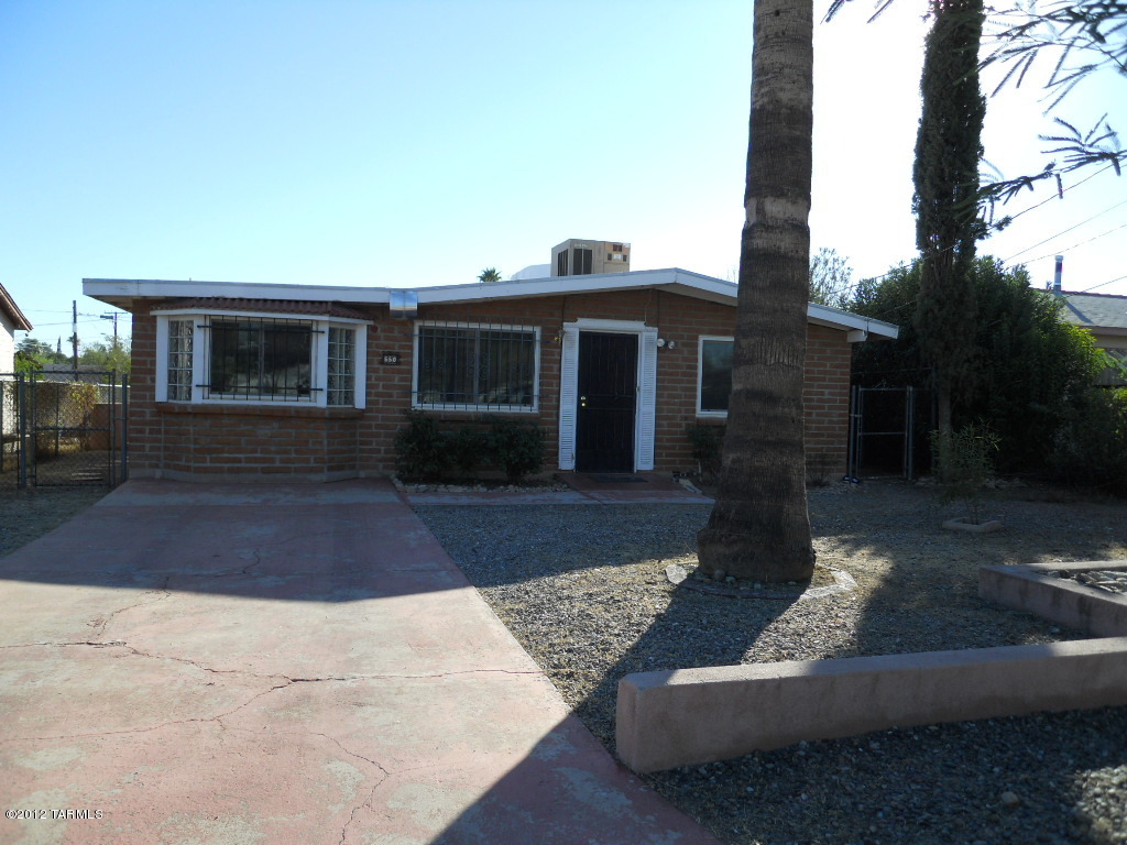 Charming 3 bedroom, 2 bath older single family home in central area. Home features security wrought iron on windows and doors.  Porcelain tile in living room, kitchen and two bedrooms. Large family room and master bedroom feature wood laminate flooring (no carpeting in house). Eat in kitchen features refrigerator, stove top and built in oven, (no dishwasher or garbage disposal). Split bedroom floor plan with Jack and Jill bathroom. Laundry room with w/d hook ups (electric dryer only). Home has A/C and large fenced back yard with storage shed.