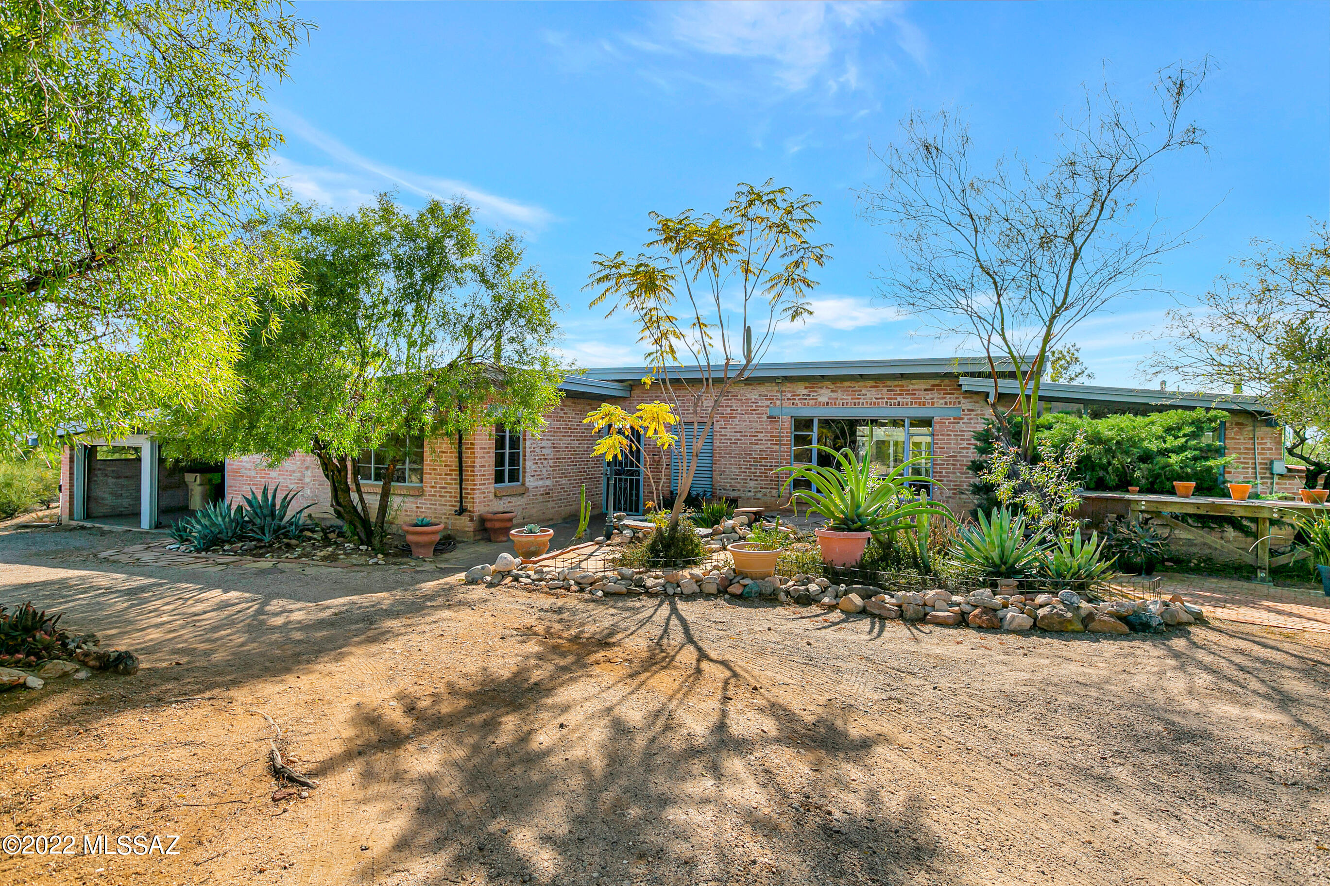 Hilltop Joesler on over one acre. Amazing mountain, sweeping city and year round sunset views. Abundant Saguaro cacti complement natural desert surroundings. Exposed tongue and groove beamed ceilings throughout much of the home. Large picture window in the living room frames fabulous mountain view. Seller has copy of original Joesler home plans. Roof re-coated 02/2022. Two car attached garage with laundry and storage.