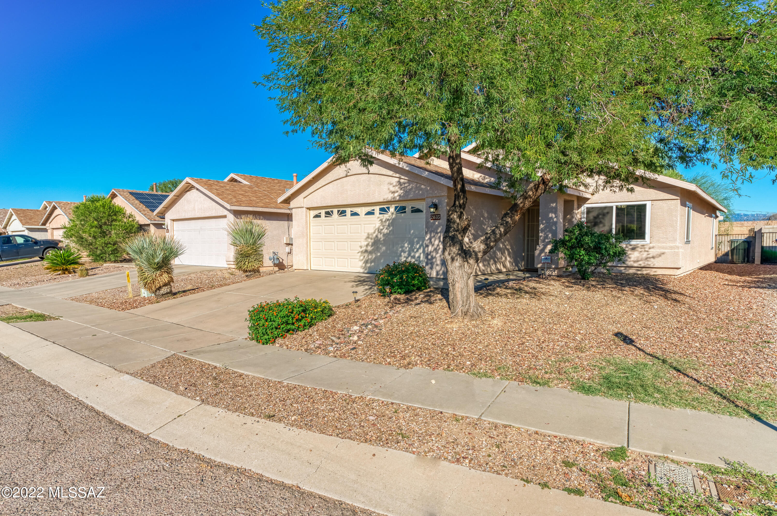 Look no further!  This adorable home is move in ready and  ready for you to make  it yours for the holidays!  The  super clean and well maintained home has updated 2022 dual pane windows throughout and 2022 sliding door. Kitchen with updated solid surface Corian countertops with breakfast bar and newer GE smooth top range. Neutral ceramic tile floors and paint colors throughout the home. 2021 Water Heater. Spacious backyard space with covered patio, mature Mesquite tree, fenced & private. Freshly painted fascia board. Location in an established neighborhood close to Silverlake Park and an easy commute to the University of Arizona, downtown Tucson and I-10. Make this your home sweet home for the holidays!  Primary bedroom furniture available for purchase on a separate bill of sale.