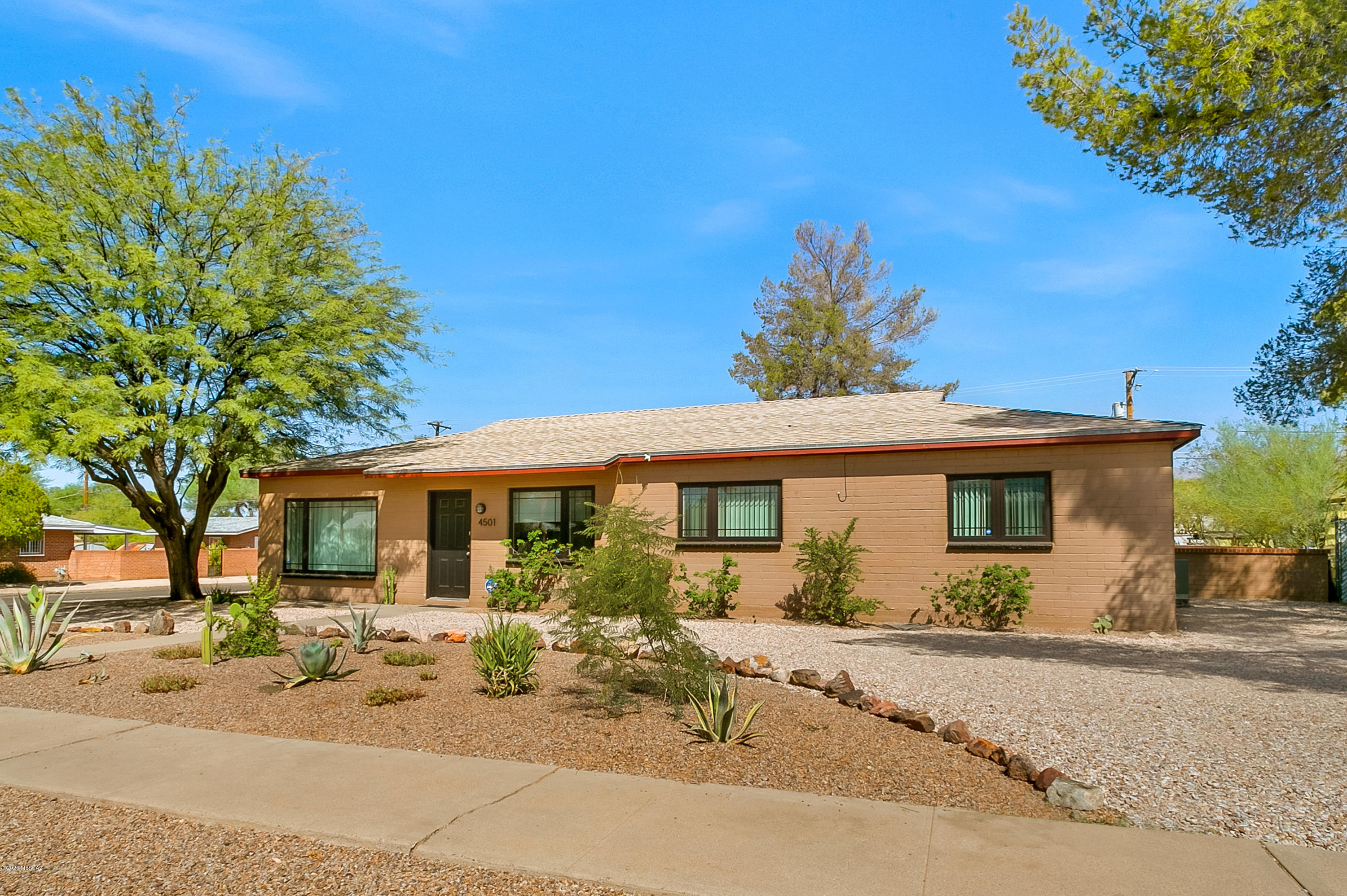 Poet's Square haven! Beautiful move in ready MCM home with complete Dwell-like renovation & touches throughout. Artfully desert landscaped HUGE corner lot for this urban setting. The main house has 4 bedrooms with a split floorplan for max privacy. Lovely & super functional kitchen with great work space & storage. Bathrooms totally renovated! Beautiful custom touches everywhere you look. The covered patio has a projector screen for those movie nights when you just want to order in. The backyard entertaining means a game of horseshoes, tetherball match, a court to shoot some hoops OR enjoy the mountain view at the fire pit. And then there's the industrial chic guesthouse! Concrete floors, tin ceilings with custom woodwork & uber cool bathroom could be a hip AirBnB/GH OR a art studio/office.
