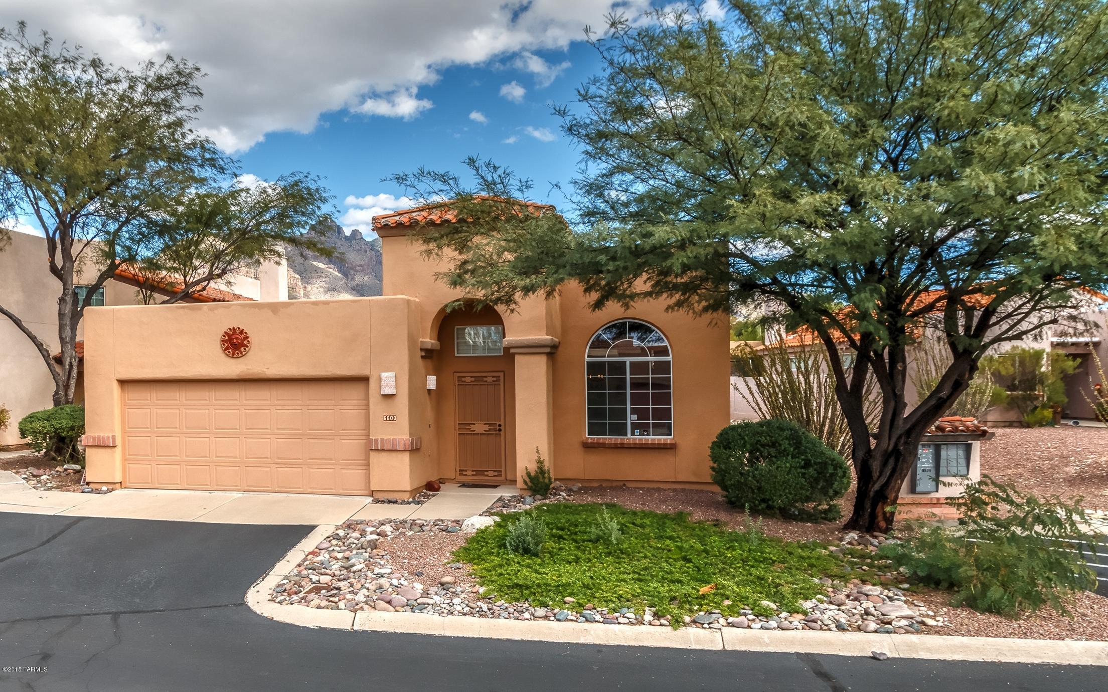 COMPLETELY CHARMING HOME NESTLED IN THE CATALINA FOOTHILLS GATED COMMUNITY OF SIERRA CATALINA ESTATES. WALK TO ORANGE GROVE MIDDLE SCHOOL. THIS QUAINT HOME FEATURES SALTILLO TILE THRU-OUT, PLANTATION SHUTTERS, WOOD-BEAMED CEILINGS, GENTLE CURVES AND ARCHITECTURAL ARCHES, NICHES AND PLANT SHELVES. ENJOY COZY RAISED HEARTH BEEHIVE FIREPLACE FOR COOL EVENING SOON TO COME. SPACIOUS KITCHEN WITH PANTRY OPENS TO FAMILY ROOM. EXTRA LIVING AND DINING SPACE OR MAYBE YOUR READING ROOM OR GAME AREA FOR THE KIDS OR GRAND KIDS. FRENCH DOORS OPEN TO A COVERED PATIO AND PROFESSIONALLY LANDSCAPED YARD. HOA INCLUDES FRONT YARD LANDSCAPING, BEAUTIFUL POOL AND SPA AREA, LOVELY GROUNDS, STREET MAINTENANCE, TWO ENTRY GATES, AND TRASH SERVICE.