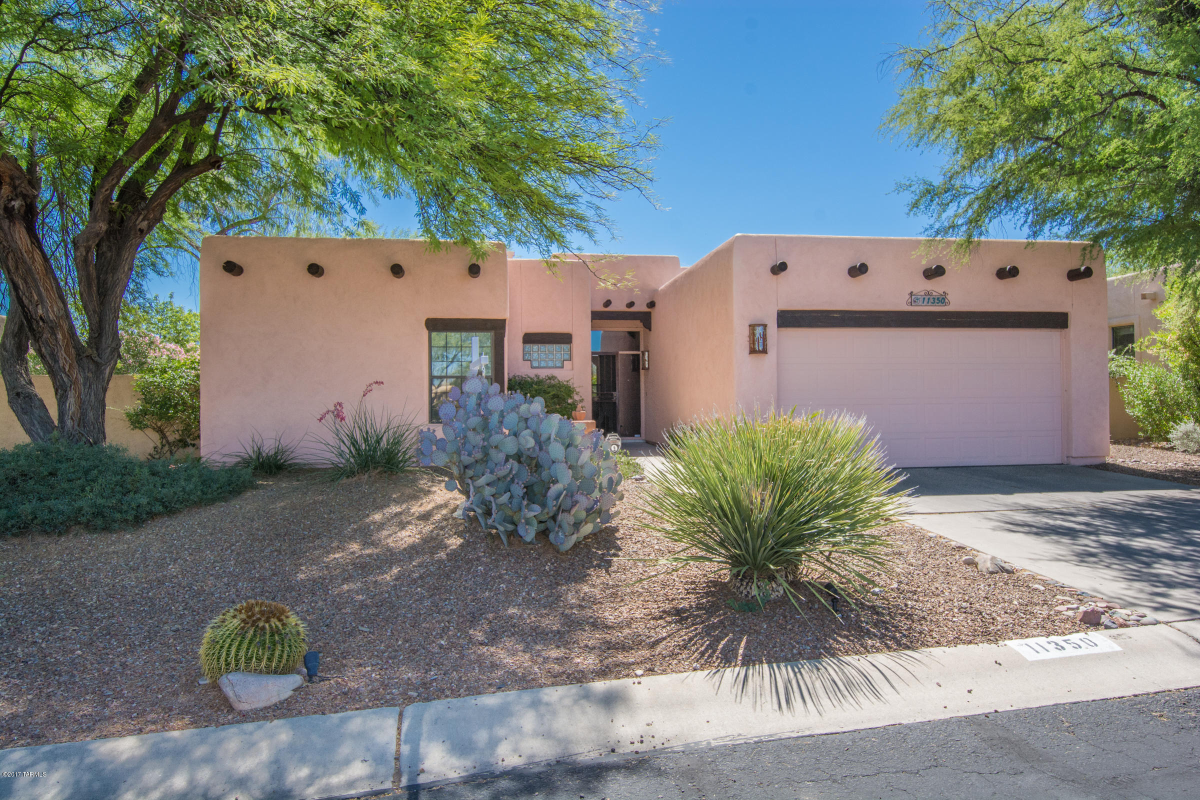 Enjoy tranquil living in this 3 bedroom split plan Santa Fe located in Canada Hills. Situated across from the par 3 3rd green of El Conquistador golf course; east facing back yard has Pusch Ridge mountain views and a peacefully landscaped yard with covered patio for entertaining. Spacious bedrooms; family room with Kiva fireplace and pecky cedar beamed ceilings in living room and family room; concrete floors; eat-in kitchen; renovated kitchen includes cabinets, appliances, hardware and lighting...window coverings newer and home freshly painted! Separate dining room and much more!