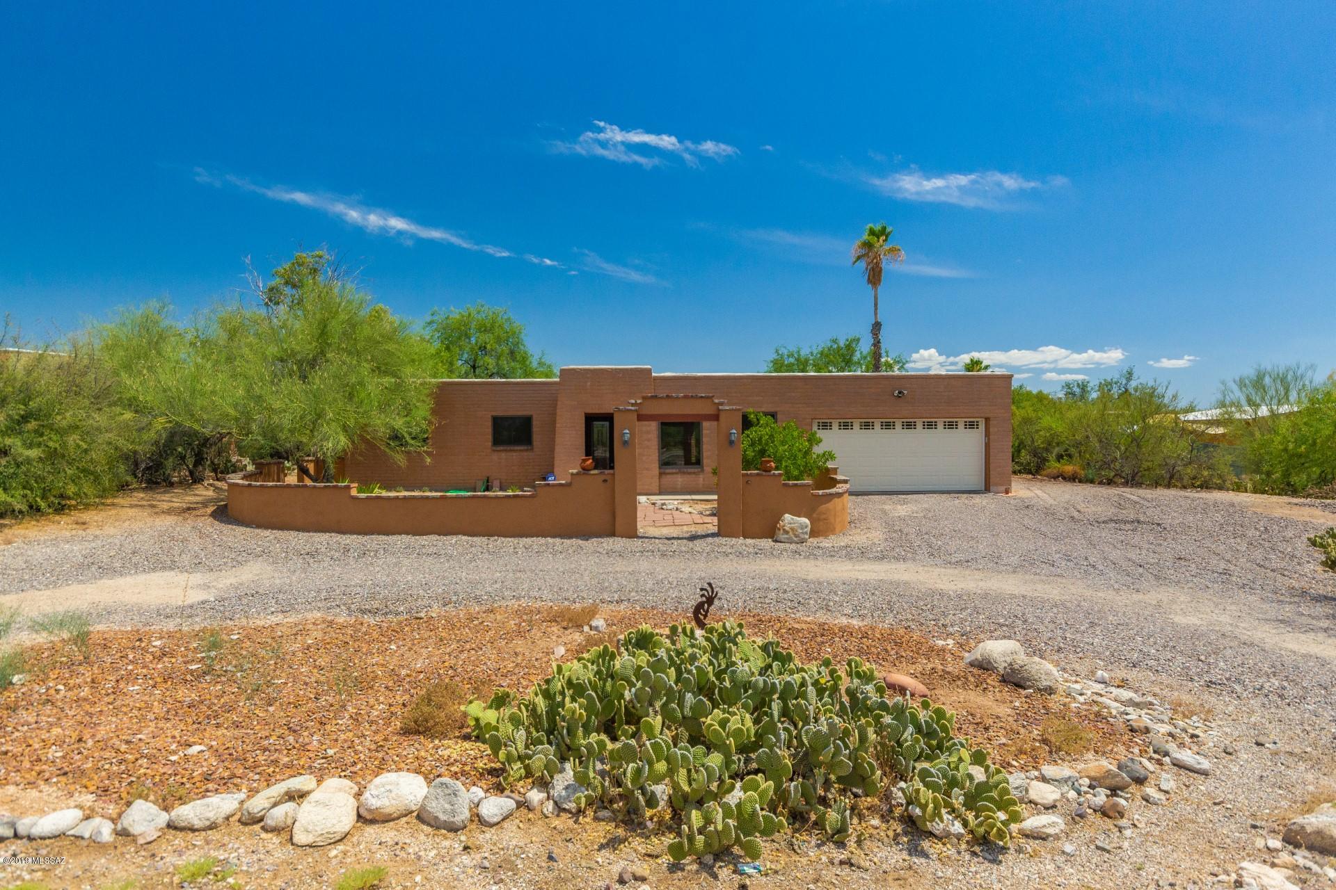 Step inside this fantastic updated/remodeled single story home that sits nestled in the amazing city of Tucson! Upon entering this home, you are greeted with gorgeous tile/hardwood flooring, brick accent walls, earth tone paint palettes and tons of natural light throughout! The island kitchen features granite countertops, white wash cabinetry, SS/black appliances, dual sinks and plant shelving. In the rear is an enclosed Arizona Room/Lanai! The spacious bedrooms offer plenty of room for sleep, study and storage. Both bathrooms have beautiful sinks and countertops! The covered back patio overlooks the expansive backyard that is comprised of the private/pristine pool, lush green grass and panoramic mountain views! Don't miss out on this one-it won't last!