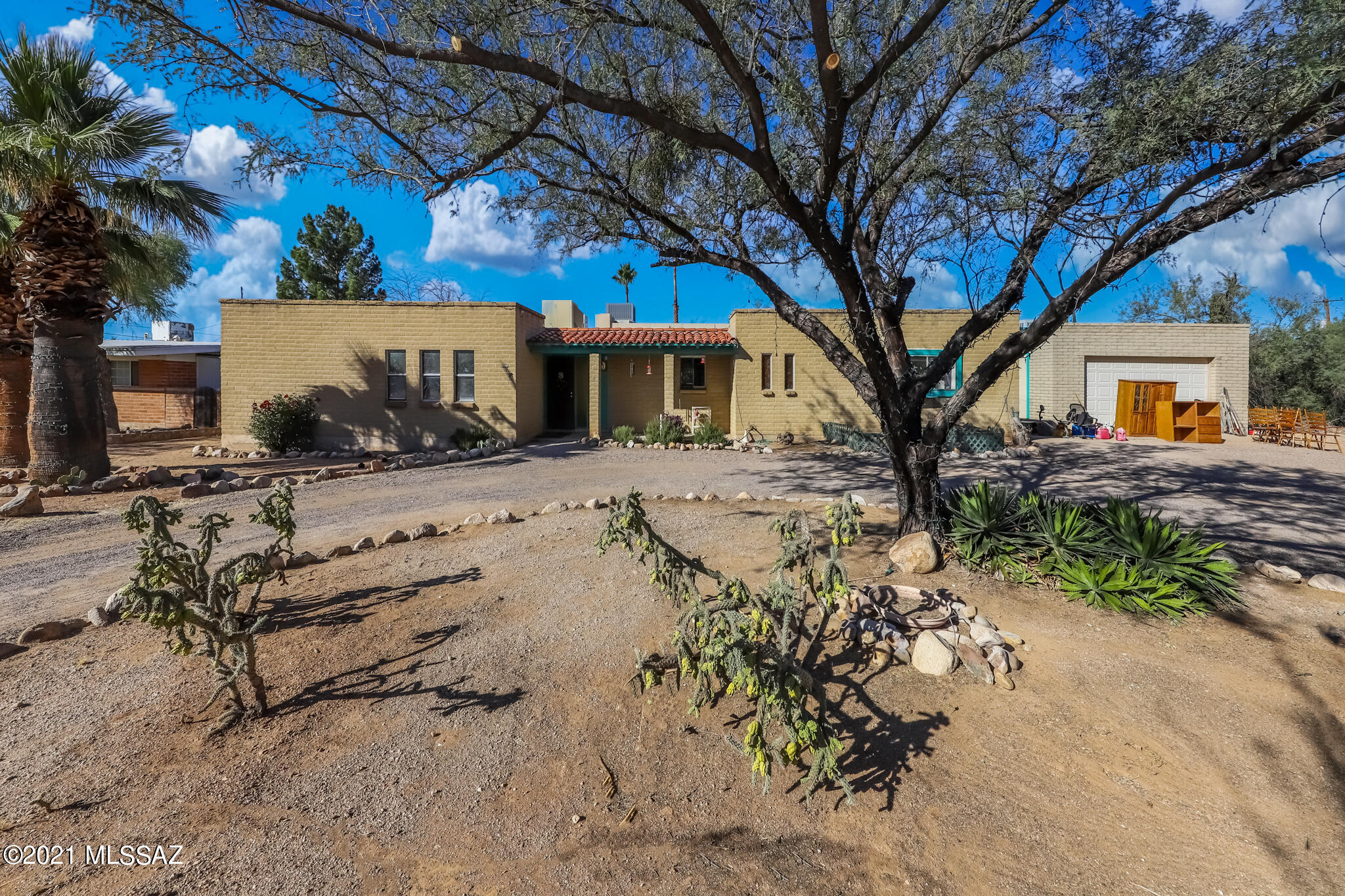3BD/2BA territorial ranch with over 2,000 sq ft of living space inside! Ceramic & saltillo tile in main areas, brick fireplace & wood beams makes for a cozy family room. Formal dining room. Updated kitchen with plenty of cabinet space, all kitchen appliances stay. Good sized bedrooms., updated bathrooms. Bonus room, uses include art room, workout room or den. Newer A/C, new carpet. Spacious enclosed backyard (almost an acre) with sparkling pool, bridge over koi pond, extra long covered back patio & ramada, great for outdoor entertaining. Detached 2 car garage with workshop area & electric. Storage shed. Mountain views. Convenient to shopping and transportation, walking distance to CDO High. Close to dog park, Linda Vista hiking trail & Oro Valley Aquatic Center. Come and take a look today!