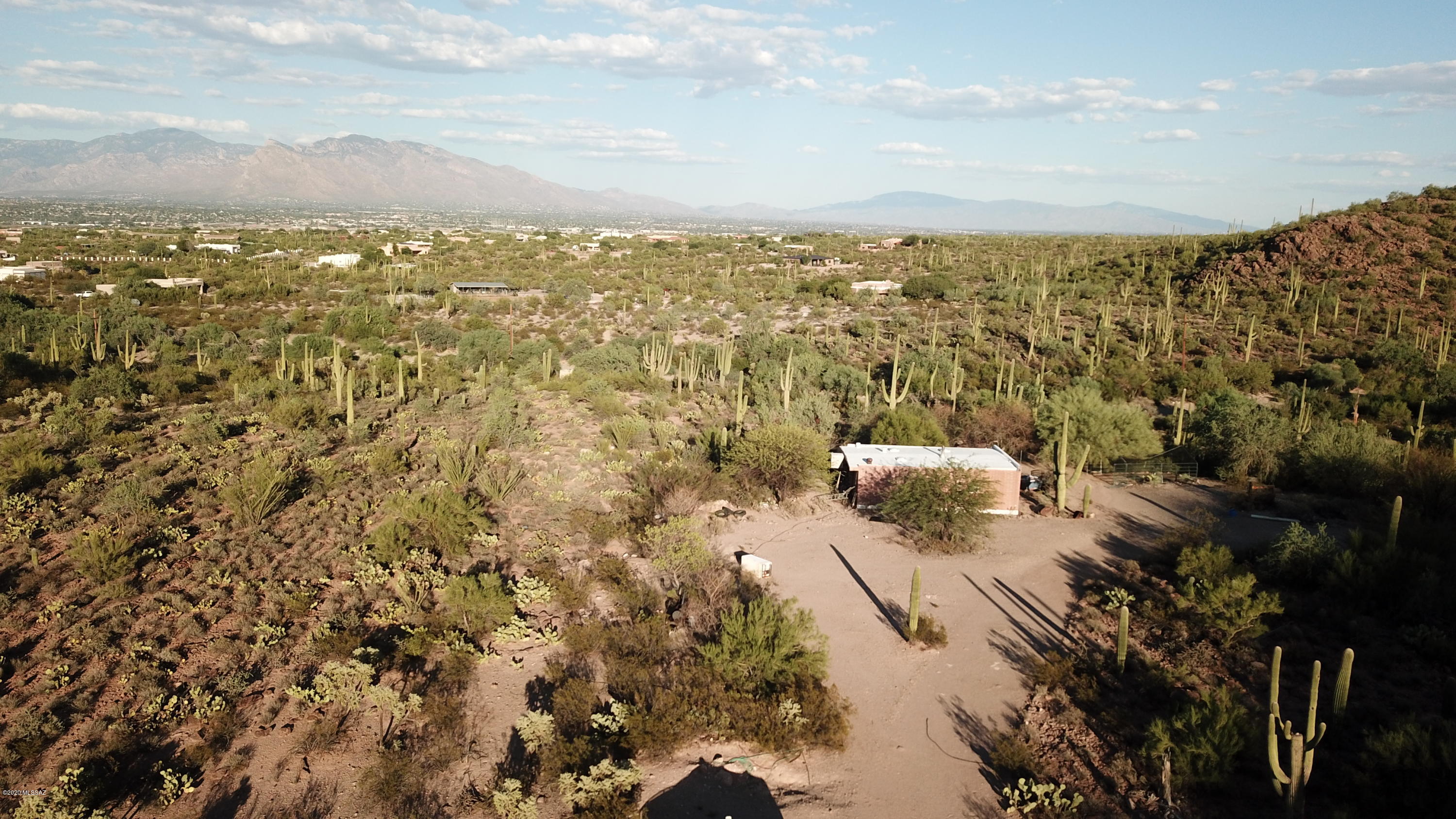 Large livable 9+ pristine ac. w/rv hookup nature, horse and privacy enthusiasts will all enjoy this private setting. This corner to corner on Saguaro National Park. This parcel is large enough to accommodate two SR homesites. Mature saguaros, panoramic views of the park, and lots of city lights. Only a few minuets to major shopping & I-10, this property offers the best of both worlds. Plenty of room to build your dram home and use this building as garage/workshop/guest house or barn.
