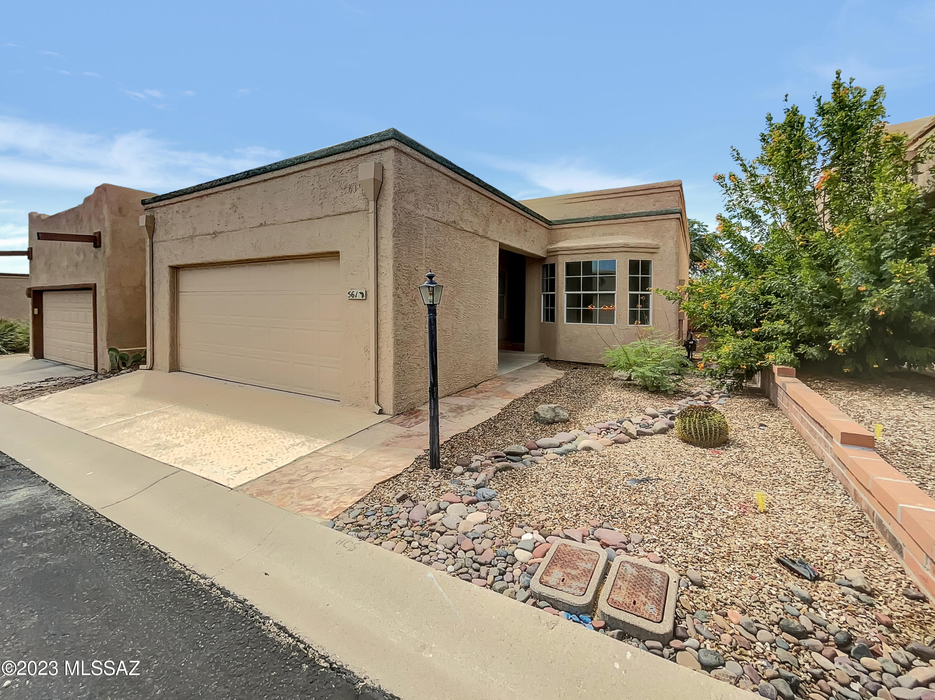 Move-in ready, updated beauty! This split floor plan home boasts LVP gray floors, fresh modern paint, and an inviting ambiance. The updated kitchen features SS appliances, double sink, ample cabinets, and a cozy breakfast nook. The combo LR/DR offers comfort with 2 ceiling fans and sliders to the AZ room. Enjoy the wood-ceilinged AZ room with serene views—no rear neighbors. The primary BR impresses with a ceiling fan, AZ room access, and a walk-in closet with built-ins. The updated primary bath shines with 2 sinks, walk-in shower, and solar tube lighting. A well-appointed guest bath, poly pipe-free, and a roof recoated in 2022 gives piece of mind about this well-maintained home. Plus, Green Valley Rec access!