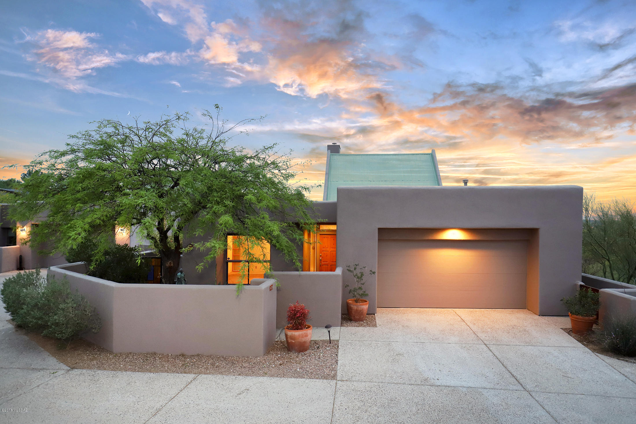 Seller will accept/counter offers between $499,000-$515,000. Nestled on a 2 acre ridge top lot with breathtaking city lights, and sunset views. Beautiful Tyson custom built southwest contemporary surrounded by acres of natural desert below. Large great room with AMAZING soaring 20 ft cathedral wood beamed ceilings and cozy fireplace. Wonderful kitchen with natural oak cabinetry, granite/stone/marble counters, gas cook-top and stainless Subzero refrigerator. Spacious master suite. Two luxurious bathrooms w/granite and travertine. Den/office area can be 3rd bedroom. Recently refinished Saltillo tile flooring. Freshly painted. Refurbished roof w/warranty. Great outdoor living spaces with covered patio, separate terrace areas and  amazing views! Estate sale. Sold AS-IS. No SPDS or Clue.