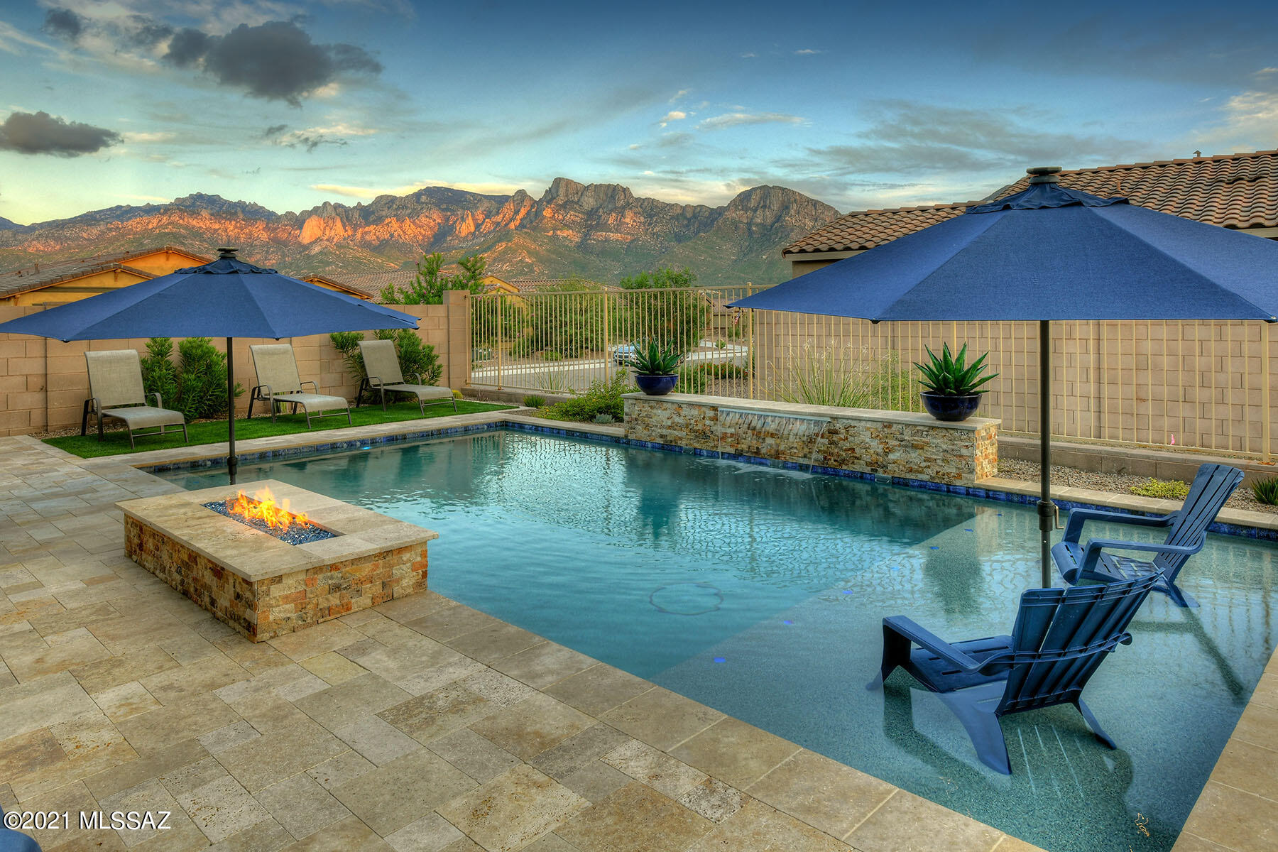 This 2020 Meritage build is truly exceptional in quality and finishes! Located in the heart of Oro Valley and close to amenities, yet tucked away in a quiet gated community on a .15 acre corner lot. This home boasts 4 Bedrooms/2.5 Bathrooms, 2342 sq ft, Chef Kitchen w/ quartz countertops, glass tile backsplash, SS Whirlpool appliances including gas cooktop, expansive island with bar seating and pendant lighting. Kitchen flows into the central great room w/ spacious dining room and slider backyard access. Upgraded 12' x 24' tile flooring run throughout the living spaces. The spacious Master Bedroom w/ spa-like bath truly encompasses an owner's retreat w/ oversized custom tile shower, separate soaking tub, executive height double sink vanity, quartz countertops, & sizable walk-in closet. There are 3 spacious guest bedrooms along w/ a full guest bathroom w/ executive height quartz countertops, dual vanity & shower/tub. Guest powder room accessible off entry hall. Enjoy the spectacular outdoor living from this professionally landscaped oasis. Features include covered & extended travertine patios, artificial grass pad, hot tub, sparkling pebble-tec pool w/ water feature, lagoon lounging & integrated gas fire pit all framed by the unobstructed Catalina Mountain views! Neighborhood features parks and trails to enjoy.