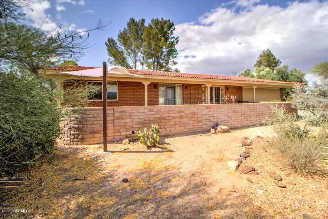 Location, Location, center of town, best mature desert setting in all of Green Valley. Unique lot with a mountain view. This home is all tile except for two carpeted bedrooms. An Extra bonus is a wheel chair accessible multipurpose room with adjacent wheel chair accessible full bathroom. Lovely, Livable and Lovable. Come see.