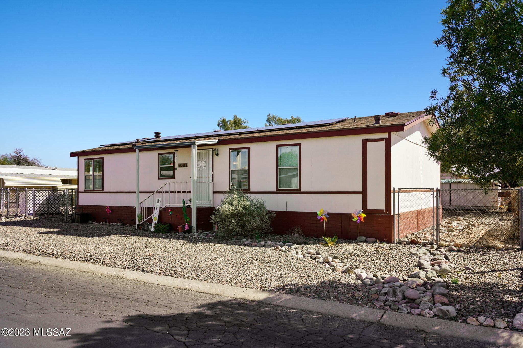 Located on the Northwest side in the Orange Grove Mobile Estates Community this home was built in 1999. Built on a premium lot of 0.23 acres, this property is just what you are looking for. The home has a split floor plan for your privacy, 3 Bedrooms and 2 Bathrooms. As you enter the home you will love the open floor plan with a large living area, fully functional kitchen and dining area. The kitchen includes plenty of counter space and cabinetry and also a kitchen nook/additional dining area. The living room with vaulted ceiling has Wood look flooring and a sliding door for easy access to the fenced back yard. This gorgeous flooring continues into the Owners Suite, which has a walk in closet and private bathroom. The bathroom has dual sinks and a shower/garden tub, and plenty of storage. All the bedrooms have ceiling fans and the updated flooring. Located near the guest bedrooms is a bathroom with a vanity, shower and tub. Heading outside you have a large yard with amazing potential, there is room for a pool and so much more. The home comes with a covered carport and a detached storage shed. Another bonus is this home has assumable Solar panels for electricity savings and is very energy efficient. The roof was replaced when the Solar was added in 2022.
The Orange Grove Mobile Estates Community has many features you will love. There is a large pool and heated spa, changing rooms, showers, basketball court, picnic areas, adventure playground, private library and clubhouse just to name a few. And don't forget the great street names.. They are all Fruits! This is a Great location because it's close to the freeway,  restaurants, entertainment, shopping, schools and NW Medical. 
What are you waiting for? this property won't last long!