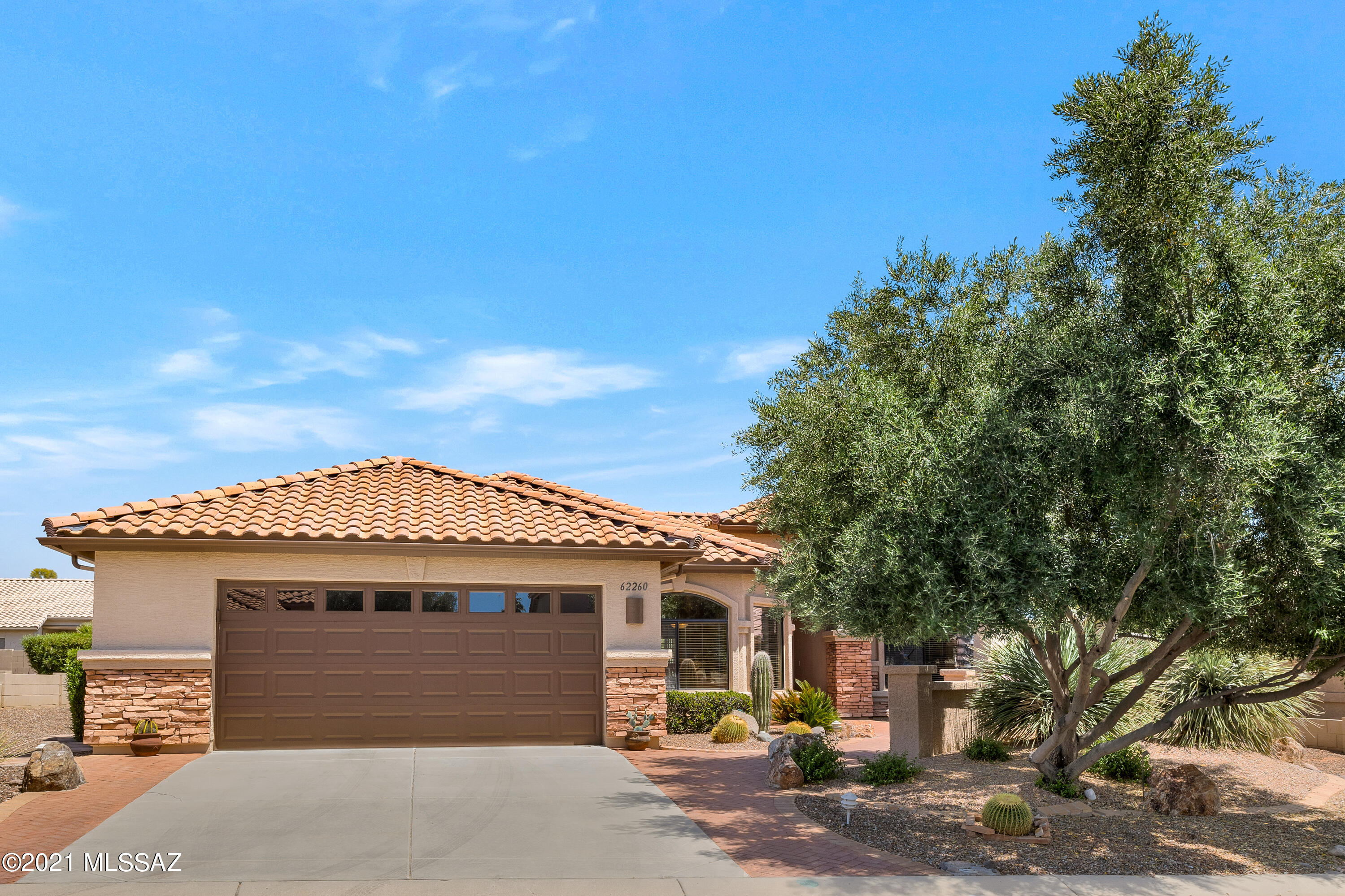 We're Proud to Present a Move-in Ready 2005 Laredo with Mountain Views from front & backyard. This 2 Bedroom + Den / 2 Bathroom / 1,864 SF / 2 Car Garage home is just what you've been waiting for! Front courtyard with palm tree & mountain views. Great room with large slider for indoor/outdoor living. Kitchen with Quartz countertops, stainless steel appliances & maple cabinets. Expanded kitchen dining area to entertain. Owner's suite with bathroom & walk-in closet. Den/Office with Murphy Bed system. Laundry room with extra storage. Garage with utility sink. Covered patio with lovely landscaping & gated yard. Extended patio to enjoy mountain views around a firepit or from flagstone wall. Fruit trees & 2 Saguaro cactus. 2020 HVAC & 2018 painted exterior. Just the place to call home!