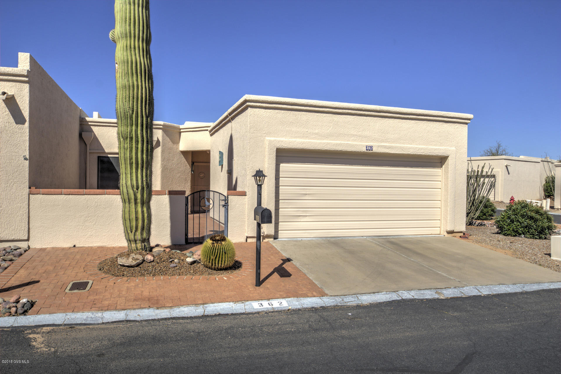 Move right in to this very nice ''turn key'', spacious townhome on a quiet corner lot. Large open Living/Dining room with high ceilings, fireplace, clerestory windows and adjoining office/den. Open kitchen with breakfast nook. 16'' tiles throughout the home. 2 car garage with wall of cabinets, Washer/Dryer and laundry sink. Walled front patio and covered rear patio. Nicely furnished including dishes, linens, ect. Short walk to GVR pool and spa. And a Saguaro out front.
