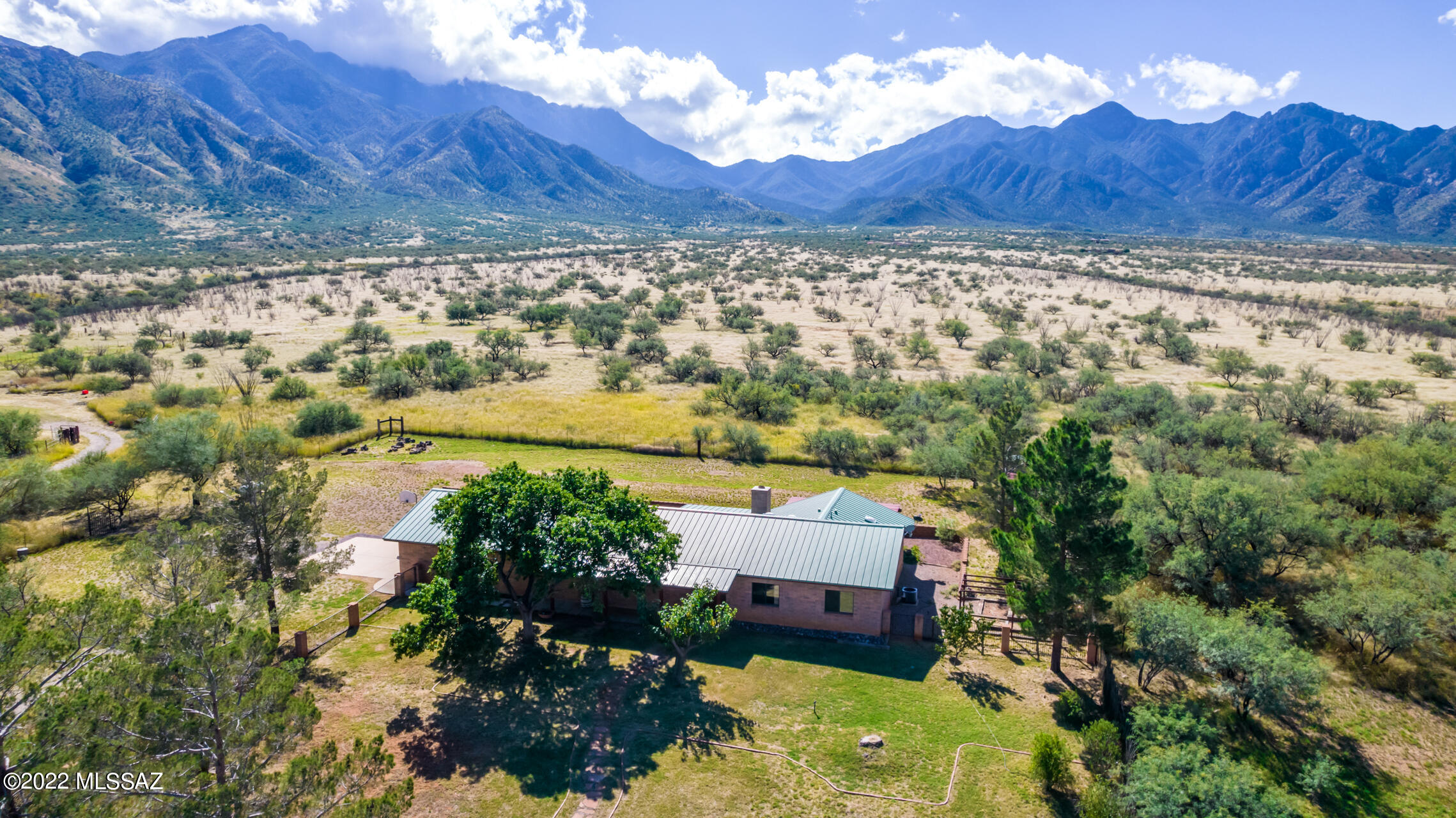 Simply stunning mountain views from this pristine ranchette nestled in the shadows of Madera Canyon.  On 4+ pastoral acres,  only 15 minutes from Green Valley & access to 60 miles of hiking & horseback trails from your backyard in the nearby Nat'l forest.  Solid masonry-built 3bd/2.5ba home w/newer metal roof & 3 y.o. zoned A/C.  Breathtaking views from every room of the home featuring custom cabinets, high ceilings, Living room w/rustic wood plank ceilings & vega beams, DR w/bay window, spacious rooms & a spa-like master bath w/claw-foot soaking tub & large walk-in closet.  Oversized garage w/plenty of storage & workshop area. Your own private well too!  Enjoy privacy & serenity in an area nationally ranked for bird watching & hiking w/unparalleled panoramic views of the Santa Rita mtns.