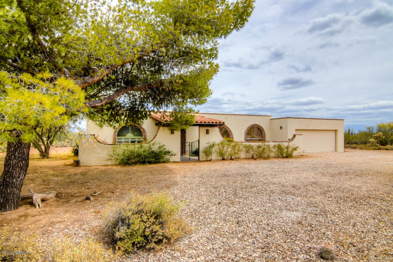 Private home on 3.6 acres set back from Sweetwater Drive. Disirable North/South exposure allows for great lighting and views in all directions.  Several mature and producing fruit trees have been lovingly maintained.  Landscaping is on timed irrigation. Ample natural desert allows space for horse facilities, chickens, RV parking or pool or... use your imagination! New flooring and paint, plantation blinds, large amounts of storage and spacious laundry room with closet could be turned into fifth bedroom OR office.  Easy access to downtown and freeway, Pima West or the UofA. Close to hiking, biking, you name it.  Hurry!