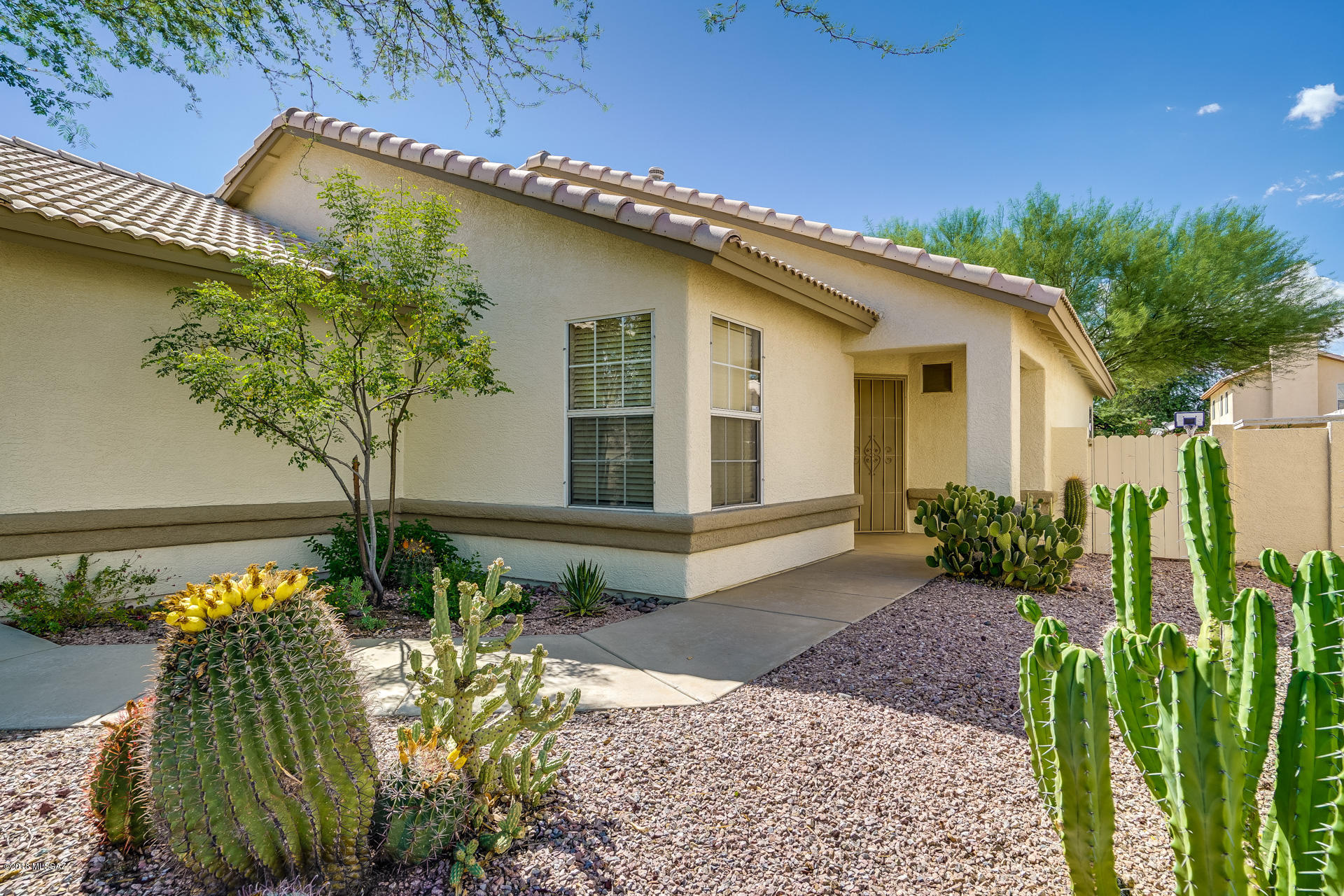 Pride of ownership truly shows in this updated 3 br 2 ba home with high ceilings, great room, lots of windows and light. Kitchen has lots of storage, island, dining area, stainless steel appliances and double sink. Master bedroom has high ceilings, beautiful wood floors, big master bath and walk in closet.  Great back yard for entertaining with covered patio, shade trees and lots of space. Conveniently located near I-10 freeway, parks, sports parks, restaurants, groceries, retail, Lil Abners Steak house and more. Less than 10 min to downtown Tucson AZ or easy trip to Tucson or Phoenix airport. Solar screens available for some of the windows.