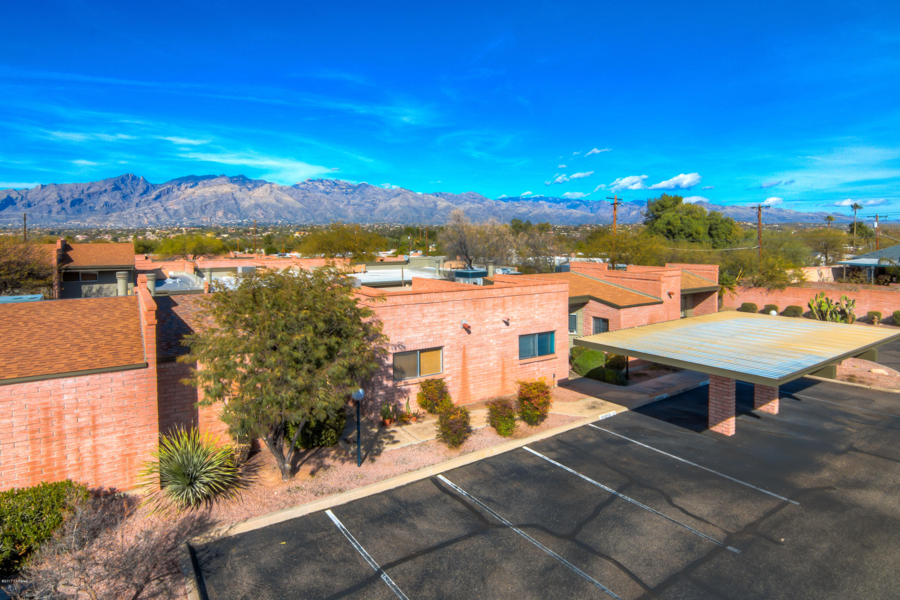 Beautifully remodeled townhouse in McCormick PL near The Loop-connect to over 100 miles of multi-use paths in the Tucson metro area! Home features solid masonry construction, 2 large bedrooms, 2 fully remodeled & upgraded baths, LR fireplace, updated kitchen with SS KitchenAid appliances, updated lighting, new flooring, fresh paint-inside & outside, new doors & hardware, new water heater, & additional storage shed.  North facing back patio even has mountain views! Move-in ready, washer/dryer/fridge convey with the sale! Heated pool/spa, manicured landscaping and covered parking are just a few of the neighborhood amenities! HOA dues cover water, sewer, trash, recycling and more. Located near popular area fitness centers, shops, restaurants, & medical. This home will not last!