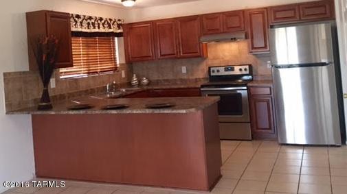 New HVAC installed. Dual cooling. HVAC & Evap!  Remodeled 4 BR, 2 BA w/AZ room & Bonus room w/separate entry (use as workshop, office, play/hobby, you decide) & extended closet/extra storage. Spacious eat in kitchen w/new cabinets & counter tops. All new stainless steel appliances & roomy pantry closet. Lg. Master suite w/lg. walk-in closet. Relax/entertain in an expansive living room & covered screened in back patio/AZ room. Nice laundry room off kitchen. Roomy back yard w/ mountain views! New paint inside, new neutral color carpets in bedrooms & living rm. Tile in kitchen, dining area, baths & bonus room. Conveniently located near shopping/mall, restaurants, entertainment, etc. Easy access to I-10 from Ina Rd. Master Cool Evap Cooler. Looks even better in person! Seller Financing avail