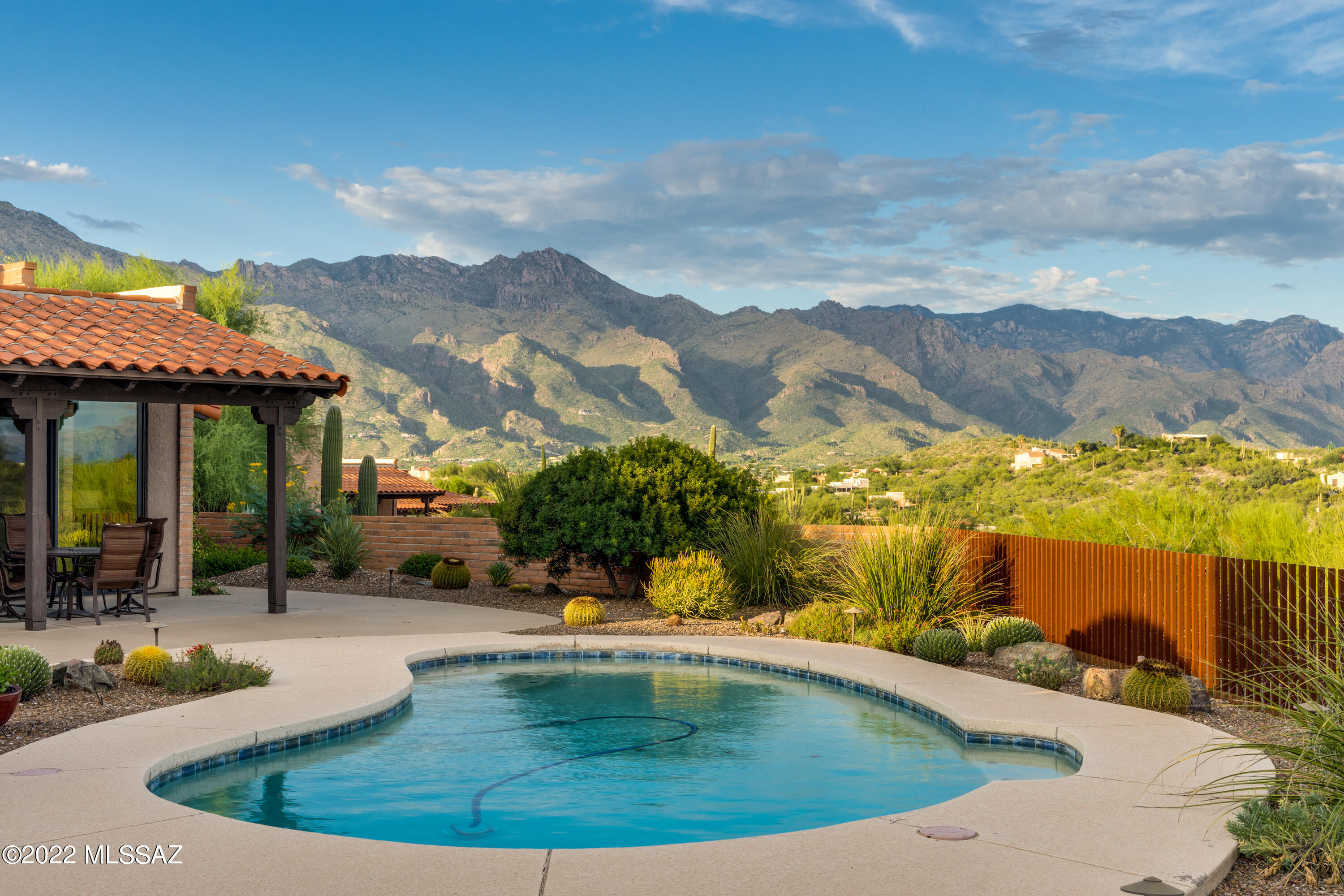 Welcome to your luxury resort style home. Upon entry through the custom front gate you will know this home is special. Behold the views for miles, Catalina &, Rincon mtns, south to Santa Rita's & city lights at night. Stunning landscaping & specialty walkway lights. Lounge in your pool & enjoy the good life. This home is striking from the moment you enter the extended foyer and see the high ceilings , then look through the home w/windows & tall sliders to the vast views beyond. Remodeled w/an eye to taste and quality. Exquisite primary bath w/custom cabinets, especially designed walk-in shower. Custom primary closet w/glass front cabinets, drawers and plenty of hanging space. Enjoy the cozy space off the primary bedroom that could be a sitting room or office. Remodeled guest bath with vessel sink w/specialty fixtures, deep tub & granite ctr. You will love the well thought out laundry area w/stacked W/D, extra cabinetry for storage. Nicely remodeled kitchen w/Maple cabinets, large drawers, pantry and views to the mtns. New LoE windows and doors, Whole home Air Purifier. Community has pool, spa, tennis court. Welcome Home to Fairfield!