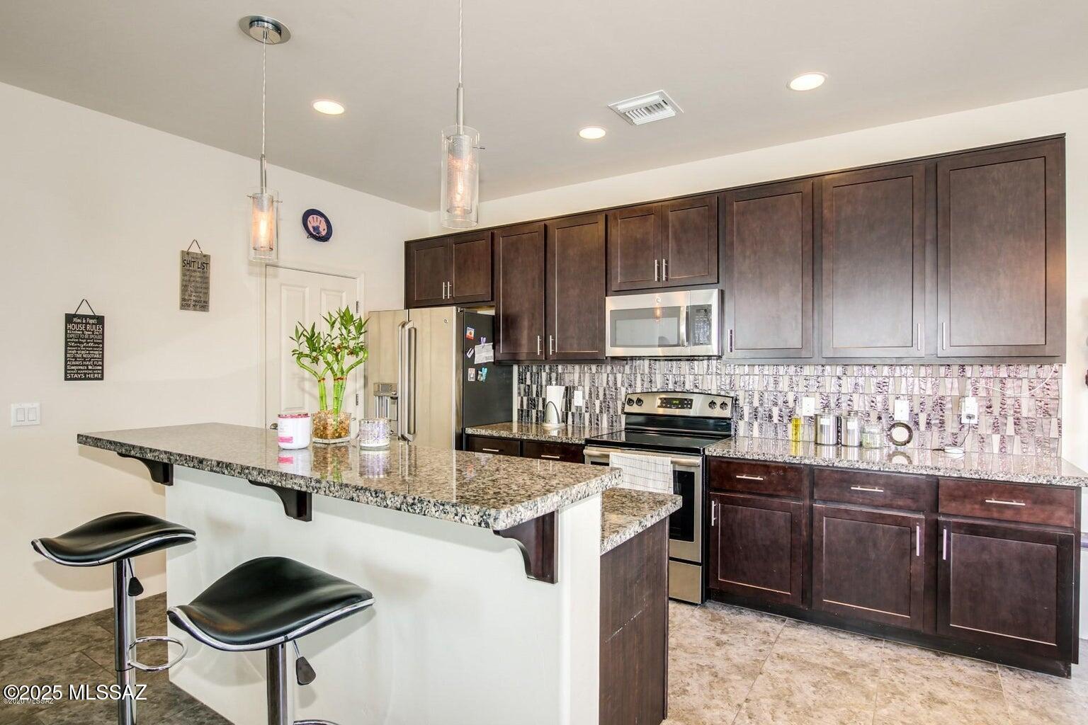Miramonte Home! Situated close to Omni Golf course, popular restaurants  & shopping! Designer Features include; maple cabinets, granite counters, bar top & SS appliances. Great Room with high ceilings & plenty of natural light. Beautiful tile flooring throughout the first level and carpet upstairs. Two car garage.