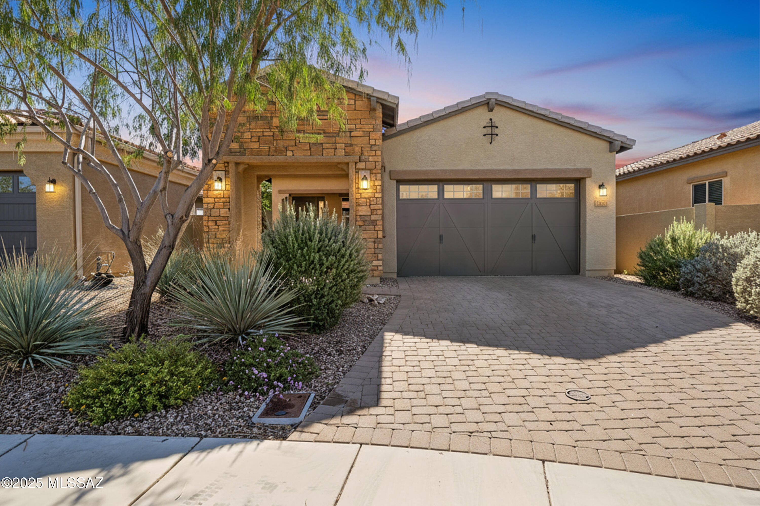 Located in Rancho Vistoso in the heart of Oro Valley, this beautifully updated residence blends modern style with a peaceful cul-de-sac setting. The kitchen showcases hand-painted cabinetry, a custom tiled island, Crate & Barrel pendant lighting, a full-height tile backsplash, open shelving accents, and a striking metal range hood. The spacious great room features a slatted ceiling and accent wall detail, while new carpet with a premium pad adds comfort throughout the bedrooms. The versatile den offers the flexibility of a home office or potential third bedroom. Outdoors, enjoy an extended paver patio with a gas line for a future BBQ, lush landscaping, mature citrus trees, and a blooming rose garden. With a strong offer, the solar panel loan will be paid in full. Community amenities include pools, a spa, recreation center, trails, and parks, all just moments away in this highly sought-after Oro Valley location.