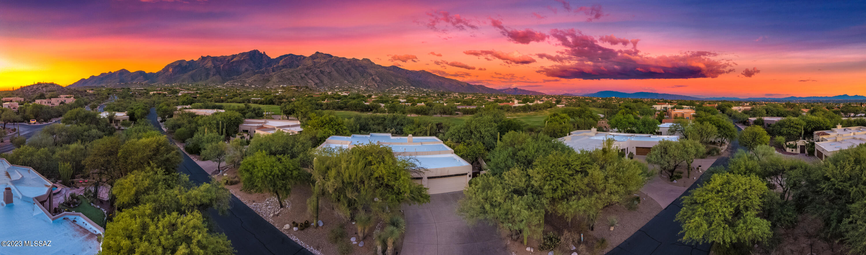 Incredible mountain and golf course views from this elegant custom Santa Fe on large Cul-de-sac Lot, over half acre site in prestigious La Paloma Ridge Estates! Highly desirable location with manned guard gate & N/S Orientation With Lots Of Mature Trees and Lush Vegetation. The perfect open floor plan- master split from spacious guest rooms & soaring high ceilings throughout! Kitchen opens to family room with fireplace. Travertine floors & Engineered wood, high end finishes throughout! Gourmet kitchen with cabinets w/ pull outs, double ovens, backsplash, granite countertops, gas range, and stainless steel appliances! Screened Arizona Room is bonus living/entertaining space! Backyard is completely private, water fountain,  low care backyard with unobstructed views of Finger Rock.  Must See Roof just recently recoated.