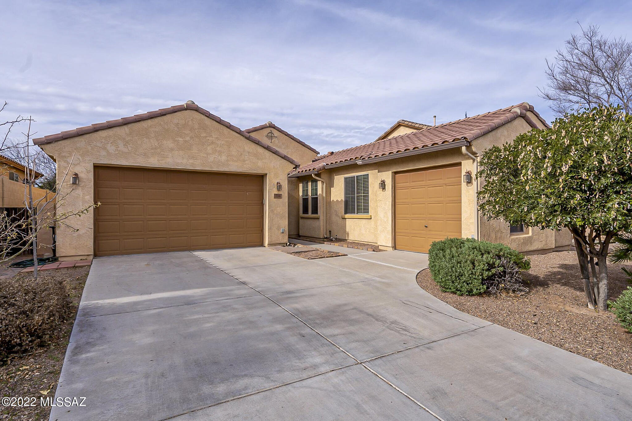 Executive home in gate Entrada Bonita. Upgrades abound in this Rancho Sahuarita gem. 3 garage spaces, large tile, walk-in shower in the main bathroom, storage everywhere, split bedroom plan and the crown jewel, gourmet kitchen with granite countertops, extra large island, gas range, double ovens and custom cabinets. The large family room off the kitchen is perfect for entertaining, and the well appointed backyard features stone benches and firepit. No more looking, this is the one!