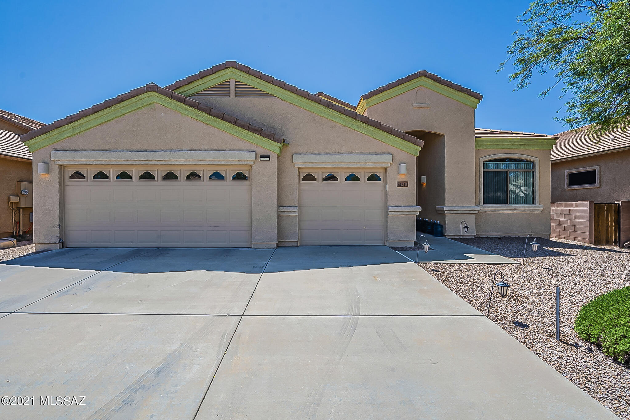 This Tucson one-story home offers a patio, granite countertops, and a three-car garage.