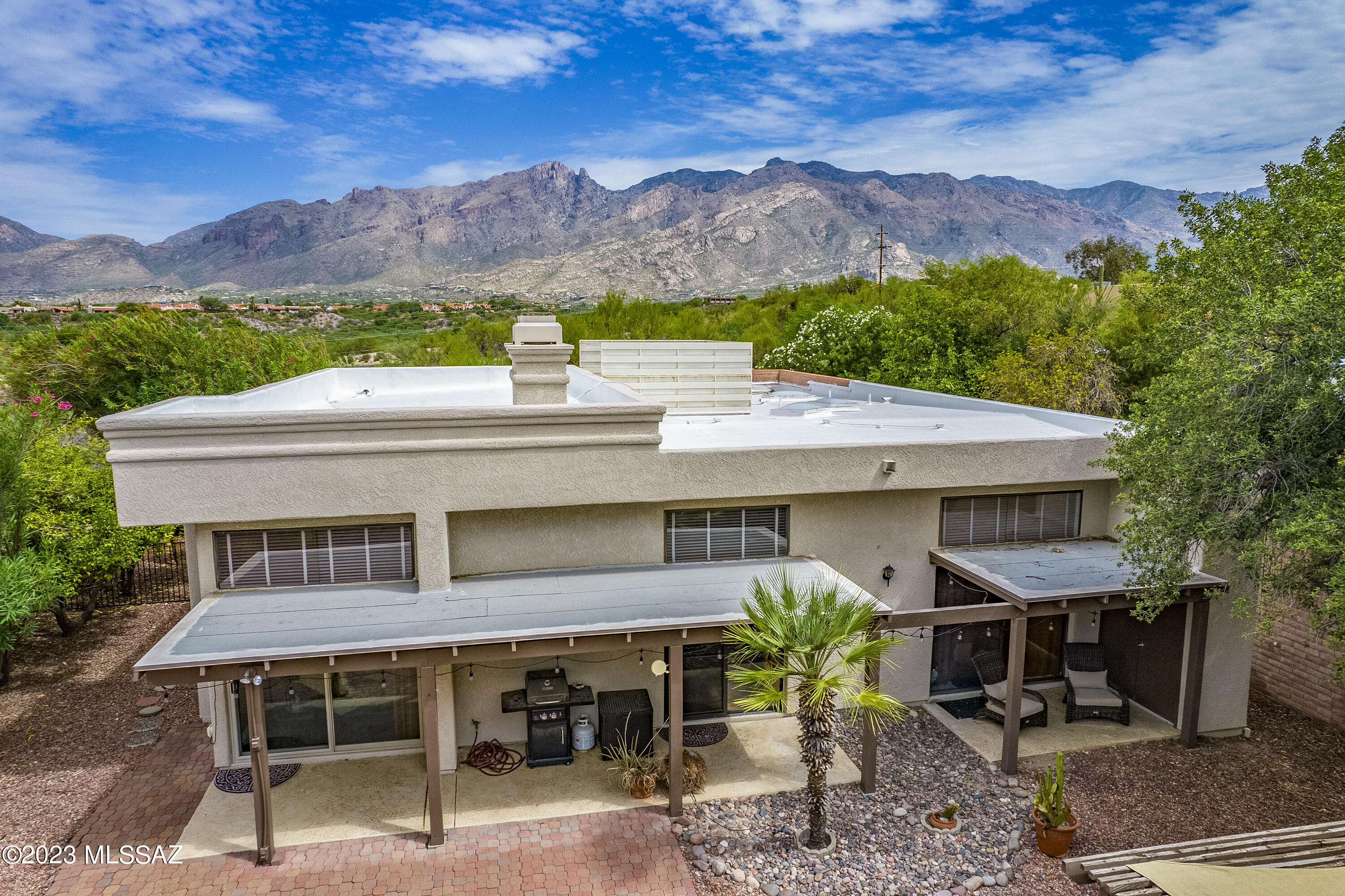 Lovely brick 3BR/2BA single-story home in gated community in the center of the foothills. Located on a large fenced lot with views of the Catalina Mountains, this home has a great deal of privacy, lots of natural light plus plenty of skylights.  Recently Remodeled from top to bottom! Remodel included Cook's Kitchen w/Slab Quartz Counters, Custom Cabinetry, Appliances-Gas Range, Bosch Dishwasher, Full Size Pantry + Window Bench w/Extra Cabinet Storage.  Updated Windows with Smart Blinds, Flooring, and Patio Concrete Texture. Incredible Great Room w/12 Foot Ceilings, Clerestory Windows + Stacked Stone Fireplace & Quartz Wet Bar w/Sink & Wine Rack.  Master Suite Features an INCREDIBLE Spa Bathroom w/Huge Spa Shower- Handheld & Rain Heads, Double Vanities, Walk in Closet, + Heated Towel Rack.