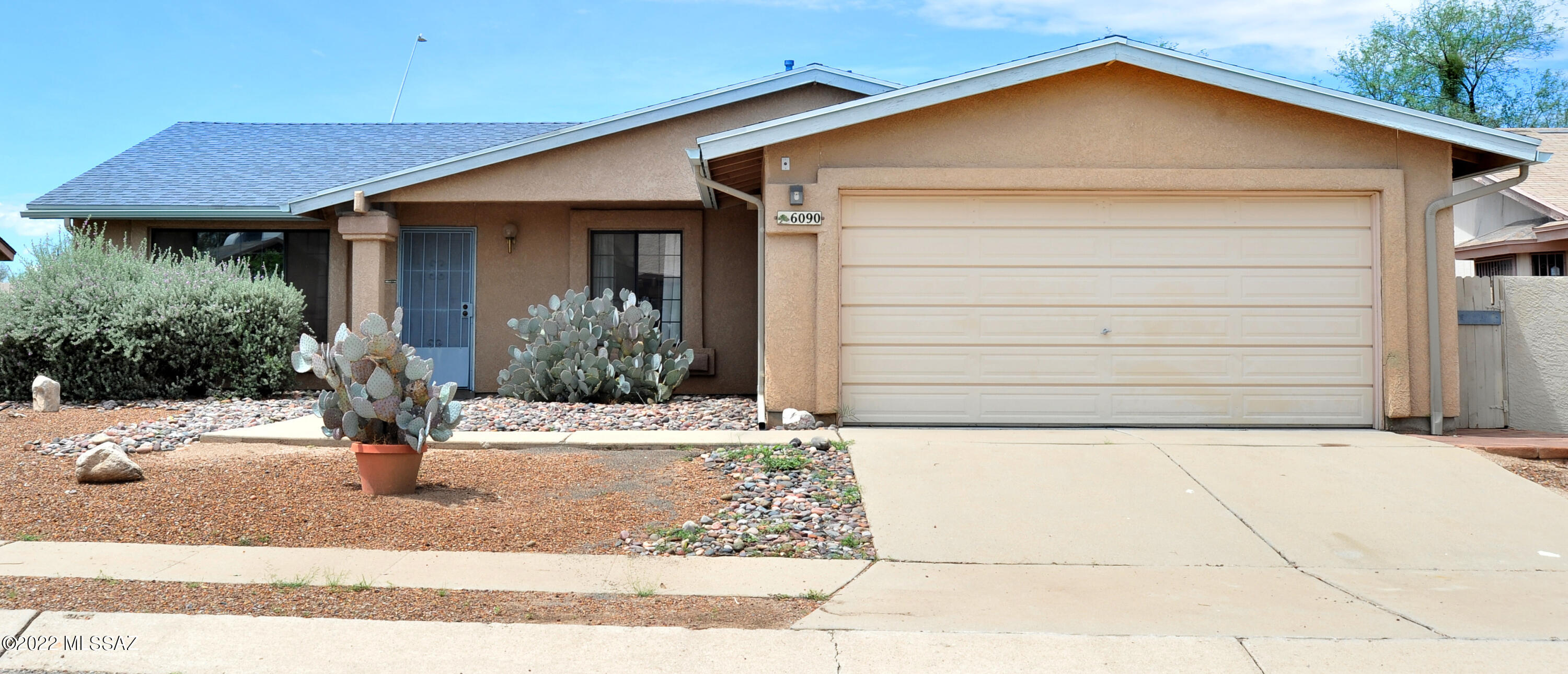 Midvale home features 3 bedrooms, 2 baths. Large kitchen with a breakfast bar as well as a dining area. Family room with a fireplace, formal living room, plant shelves. Extra large primary bedroom w/walk-in closet. 2 car garage, large shed in bkyd also dbl access gate. Single owner home. Close to I-10 & I-19, shopping galore. Alarm system conveys ''As Is''.