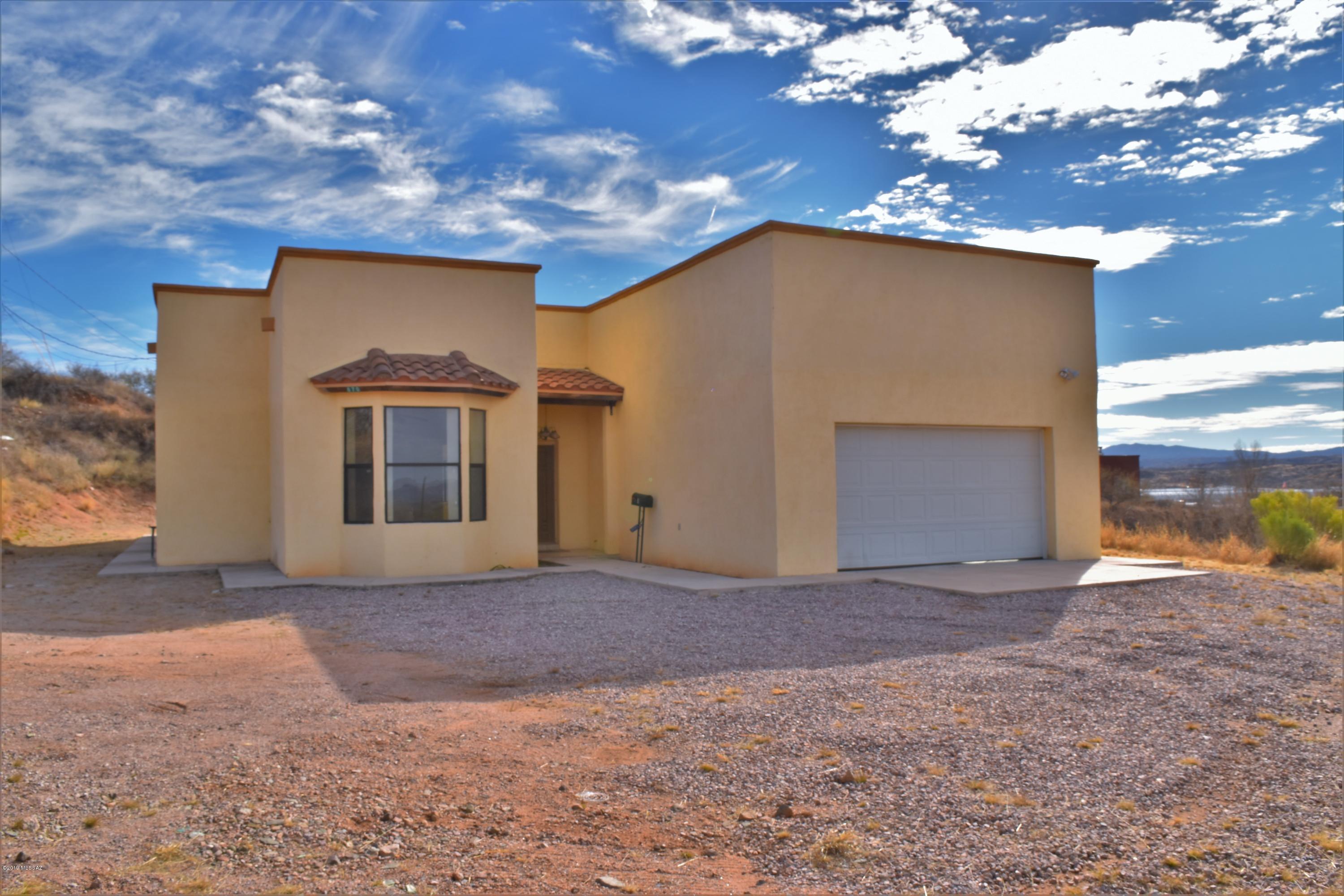 Territorial Style home situated on a hill with panoramic sunset mountain views. Home is designed with an open floor plan, formal dining and breakfast nook. Bathrooms are beautifully decorated with upgraded cabinetry and granite counter tops. Oversized tile through living area and upgraded ceiling fan throughout!
