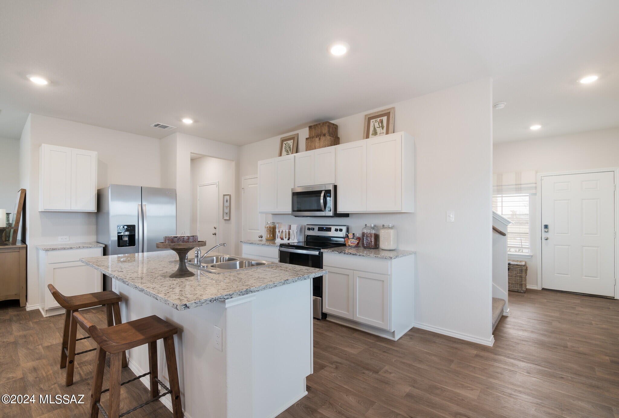 Discover your dream home in the desirable Senita Crossing Community with this two-story gem. Featuring an inviting open-concept floor plan, this modern abode boasts an impressive array of high-quality finishes and amenities that are sure to exceed your expectations. Enjoy the perks of a community park just steps away, with easy access to I-10, DMAFB, TIA, University of Arizona, and Downtown Tucson. Some of the included features are Stainless Steel Appliances including Microwave, Dishwasher & Gas Range. Kitchen Island, Walk-in Pantry, White Shaker Cabinets, with Granite Countertops plus Tile flooring in most areas, Tankless Water Heater Smart Home Technology and much more!