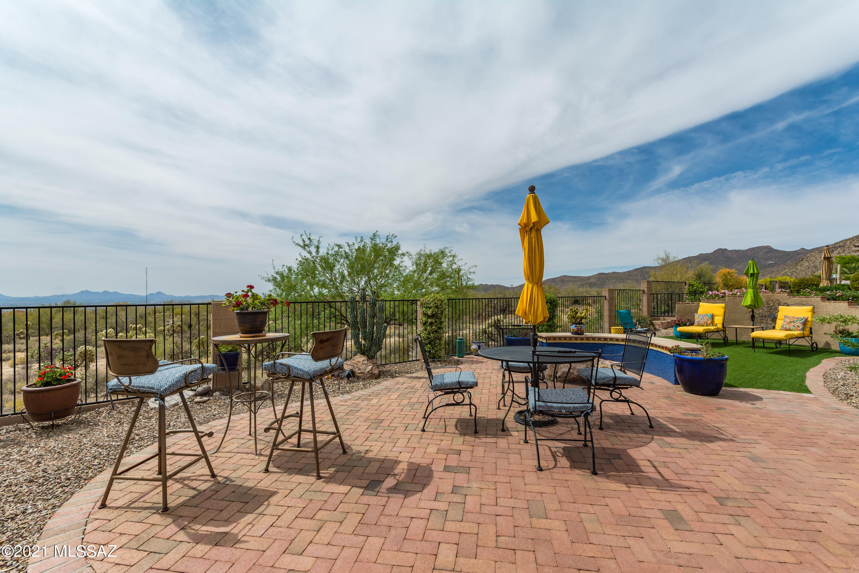 Highly desired Hillsboro model with panoramic views.  Private location - backs to the Tortolita Preserve - nature's beauty. Many upgrades and improvements: all tile floors, rain gutters & spouts installed, front door arched iron gate enclosure, added 4 sun control remote controlled sun shades, artificial turf in backyard, added custom dual pane UV resistant sliding door & screen from Anderson Doors in dining room area 2020, added natural gas fire-pit in back patio, installed brick patios front & rear, enclosed property w/fence & 2 gates, replaced garage door 2020. Backyard is beautiful, interior is custom and inviting. Location is great. Some furnishings available on separate bill of sale.