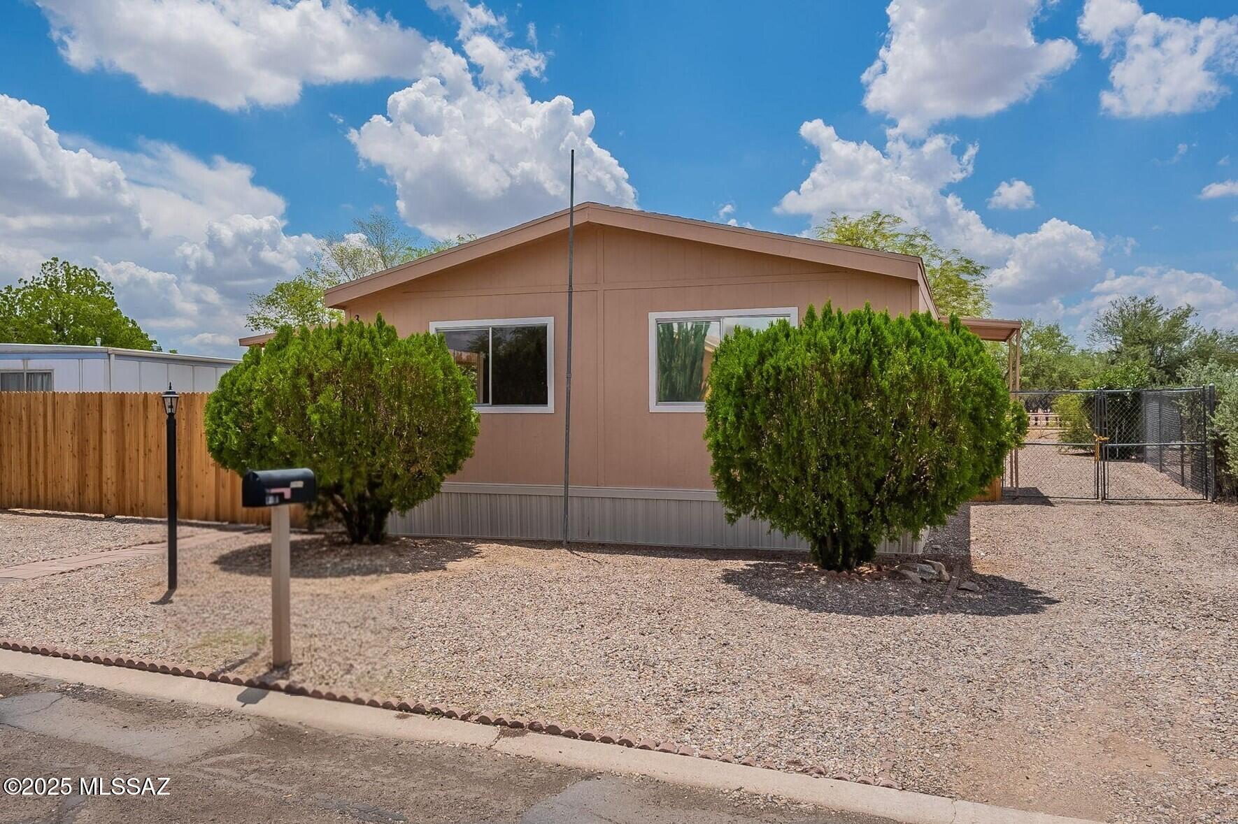 No need to look any further! Just unpack and relax in your completely remodeled home with a fully fenced backyard. Large kitchen boasts brand-new cabinets, countertops & stainless-steel appliances! Giant walk-in kitchen pantry for plenty of extra storage. New laminate, vinyl & carpet flooring too! Both bathrooms feature all brand-new cabinets, countertops and fixtures. Brand-new AC condenser & coil is ready to keep you cool this summer. Covered front patio as well as an awning to cover the back door too! Double chain link gates open to the spacious, fenced backyard with small storage shed. Enjoy access to the community pool, spa, clubhouse, playground & full basketball court in this well-maintained community with no age restrictions. Conveniently located near I-10, shopping & hospitals.