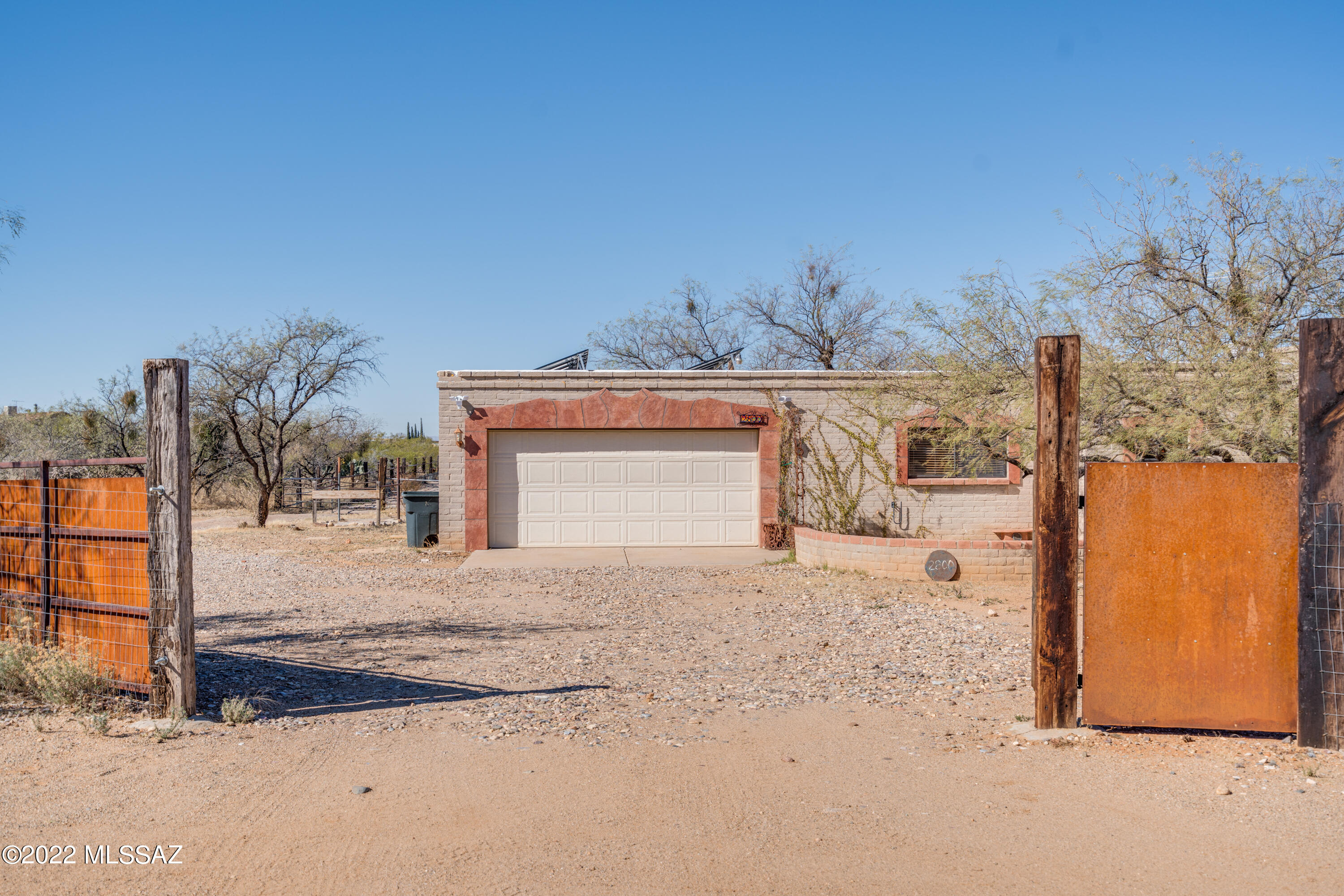 Charming southwestern style home with 3 bedrooms plus den. Open great room with cozy fireplace. Owner's suite features jetted tub, large walk in closet and a nook for a home office, or sitting area. Back courtyard with water fountain. Large barn and horse facilities with an arena.  36 x 72 building that has endless potential for toys, horses, vehicles, etc! Flat, usable space for all you can imagine. Lots of charming details throughout! Owned solar!
