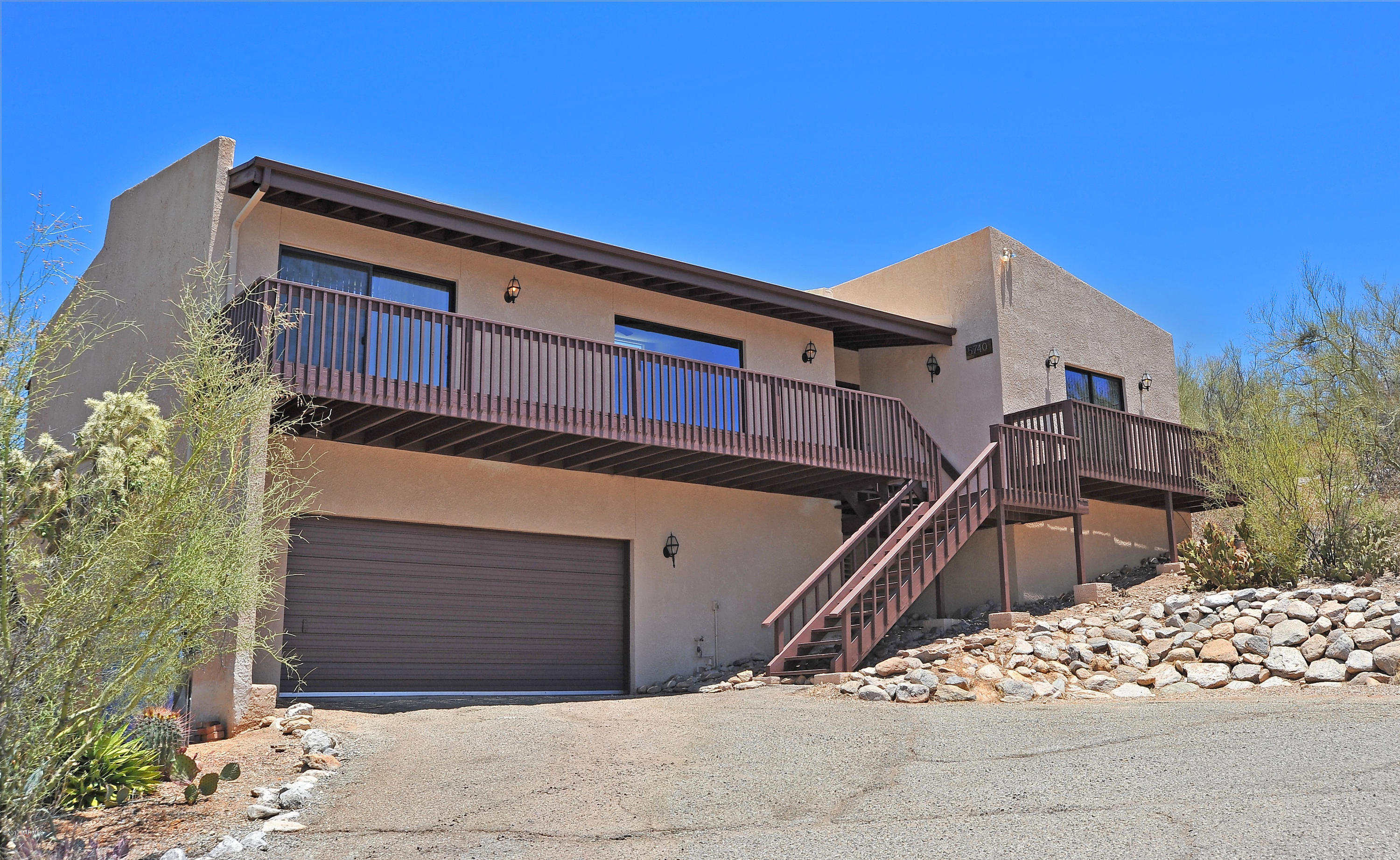 This home has incredible city and mountain views. Open floorplan w/remodeled kitchen. Gorgeous cabinetry, SS range,microwave and dishwasher. Side by Side fridge with ice and water dispenser.granite countertops and subway tile backsplash. Track lighting and lots of recessed lighting too. High ceilings. Family room with 2 ceiling fans,sliding glass door leads to a balcony with incredible city views. Another sliding glass door leads off of kitchen to 2nd balcony with incredible mtn views. Over an acre of lush desert w/walking paths and gorgeous rock waterfall. Plenty of room for a pool. Lg garage with added workshop. Master bath has two sinks,tiled backsplash and beautiful countertops. Freshly painted interior, dist 16 schools. Fans in all rooms. New carpet.Close to shopping and restaurants.