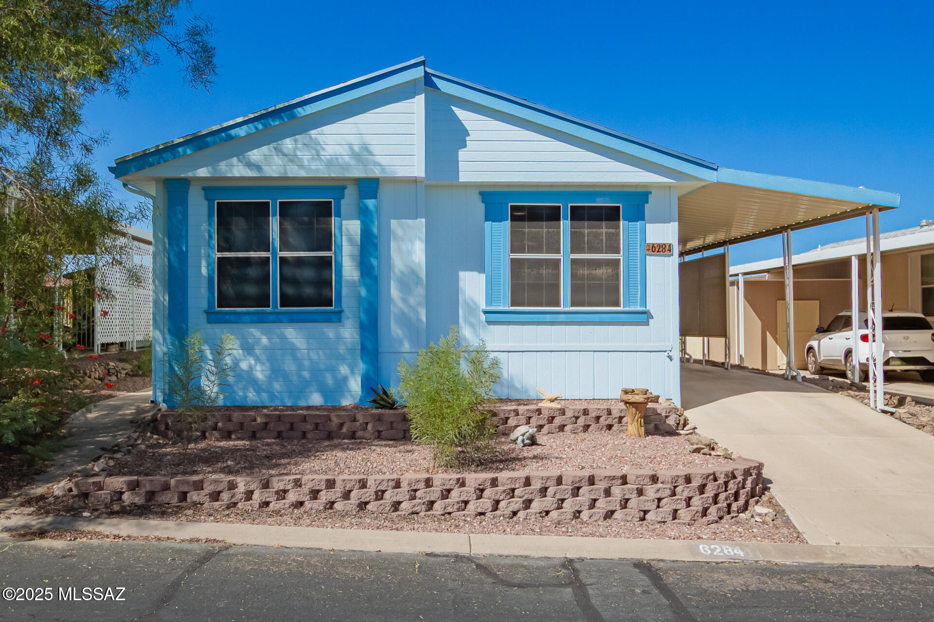 Absolutely charming home in a 55+ community. Home sits high in this community allowing for a view of the Catalina mountains to the North and Rincon mountains to the East. Freshly painted inside and out. Roof replaced approximately 3 years ago. Upgrades include flooring in the kitchen, dining area, bathrooms and hall. Upgraded countertops, sinks, faucets and blinds and replaced newer toilets. Gas stove replaced approximately 3 months ago. Pedestal sink in main bathroom, recently replaced ceiling fans and chandelier. You'll enjoy sitting under a covered ramada with a privacy screen. Wonderful community for a leisurely walk. Take in activities at the clubhouse or enjoy a relaxing swim at the pool. Don't miss out on this one.