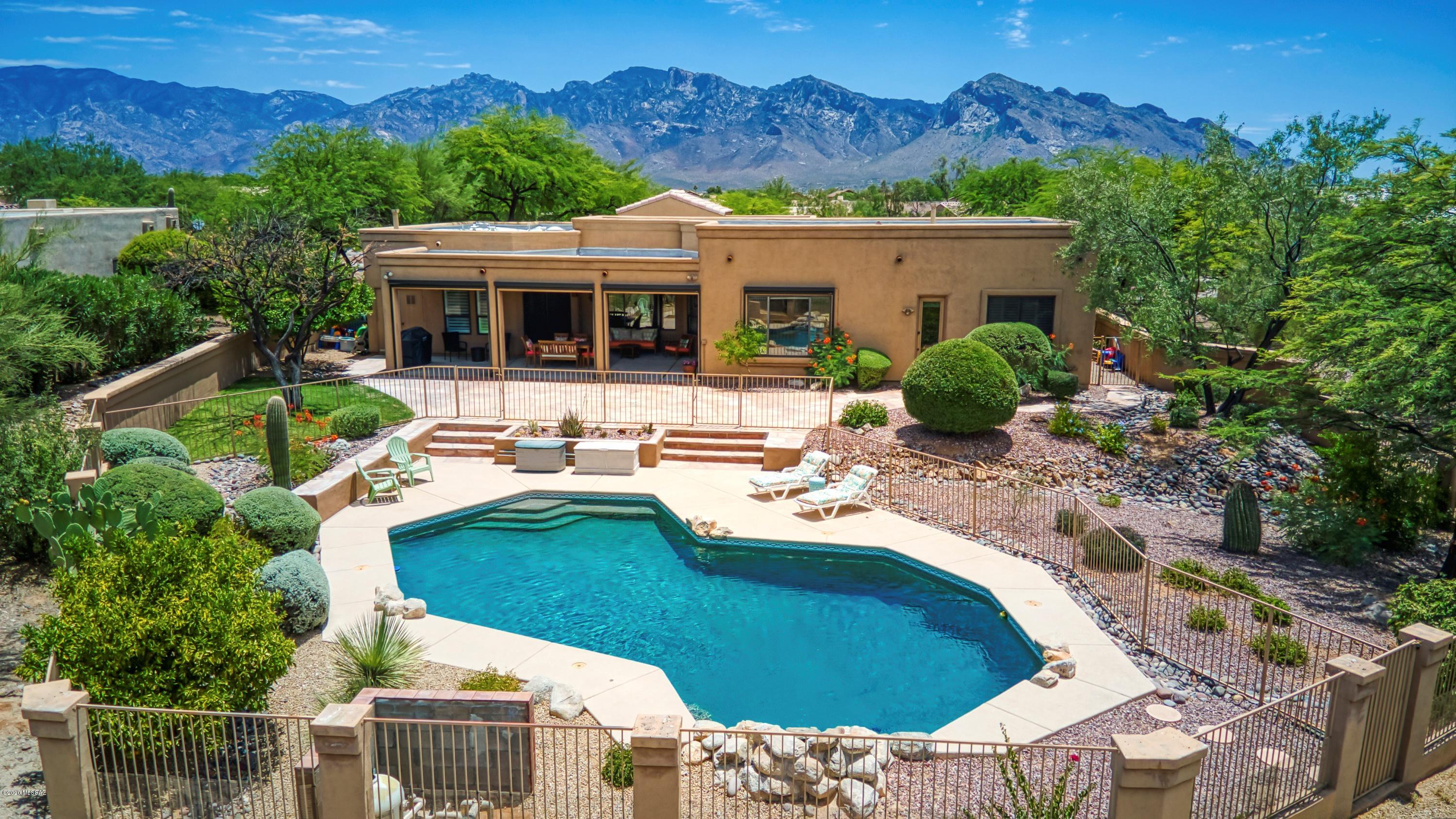 Private, resort style living in a highly desirable Oro Valley neighborhood! Beautiful, move in ready home features 4 br, 3 full baths, open concept kitchen/family room, and landscaped front and rear yards. Updated kitchen, family and laundry rooms with custom cabinetry; new kitchen appliances; carpet; and exterior shutters. All bedrooms are large with generous closet space. Master retreat has dual sinks, soaking tub, separate shower and walk-in closet. Private, park like backyard with large flagstone covered patio, mature plantings and spectacular pool. Curb appeal galore with huge circular paver driveway and plenty of room in the oversized 2.5 garage, with cabinetry and work bench. Catalina Mountains views and spectacular sunsets in this very special home. Agent related to seller. Virtual Tour in photos.
No showings until 7/10/2020